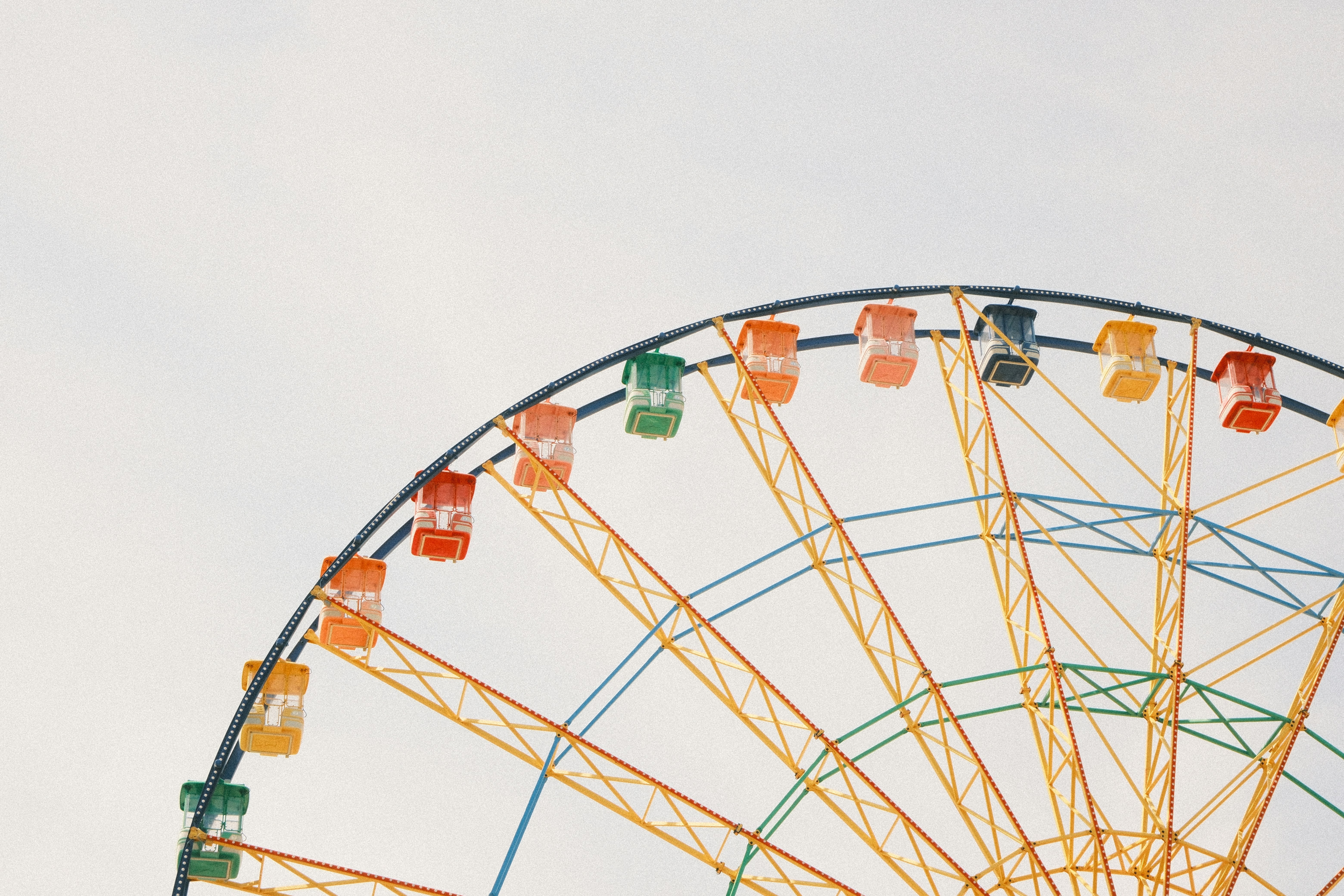 Colorful ferris wheel against a pale sky