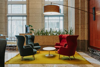Four chairs arranged around a coffee table in a lobby.