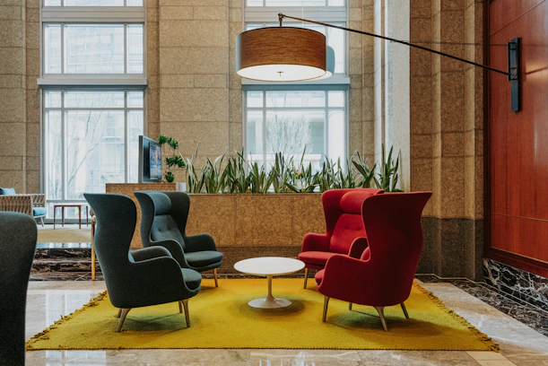 Four chairs arranged around a coffee table in a lobby.