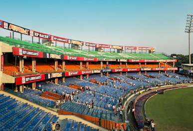 Empty blue stadium seats under a bright sky