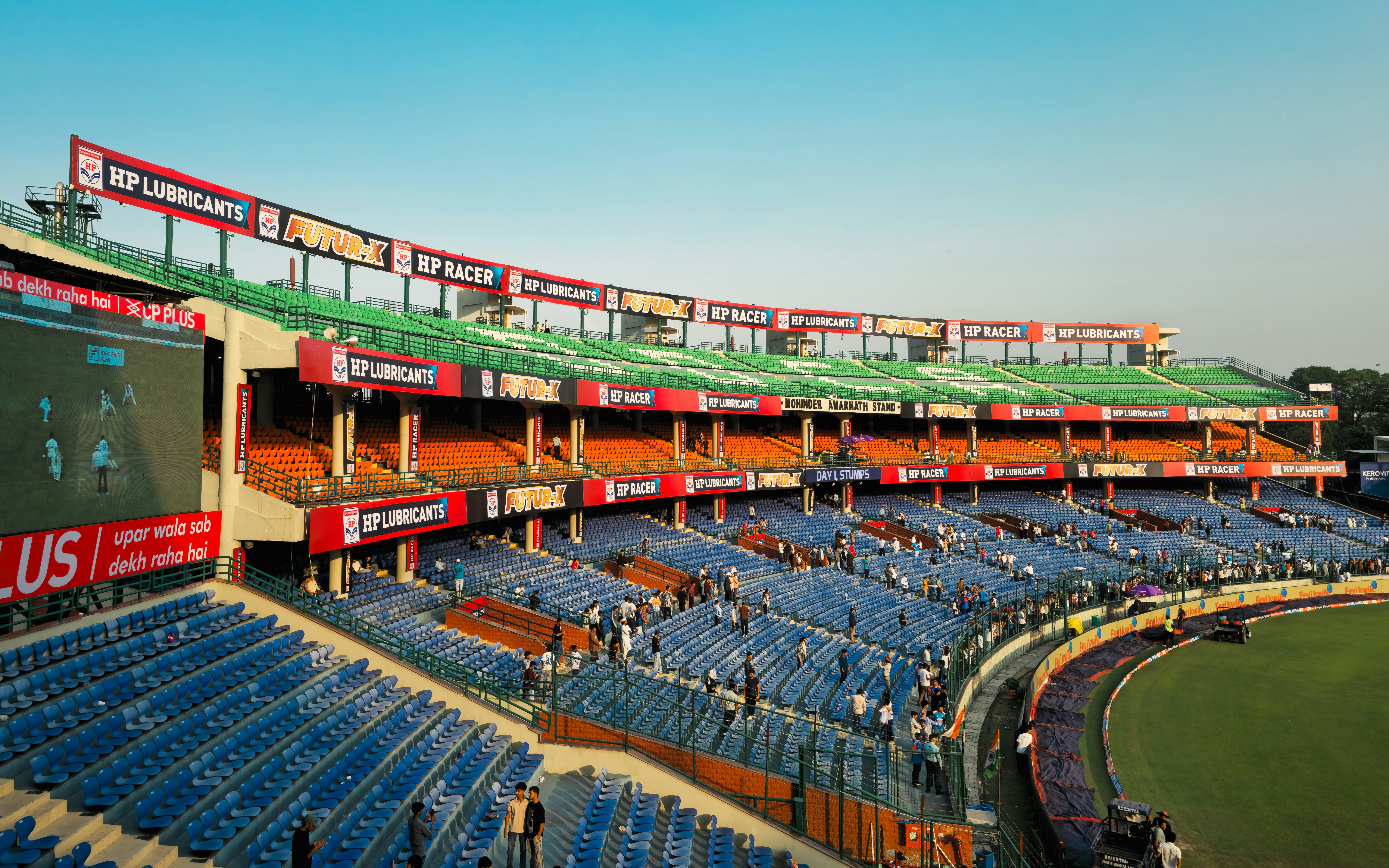 Empty stadium seating with a large screen and advertisements
