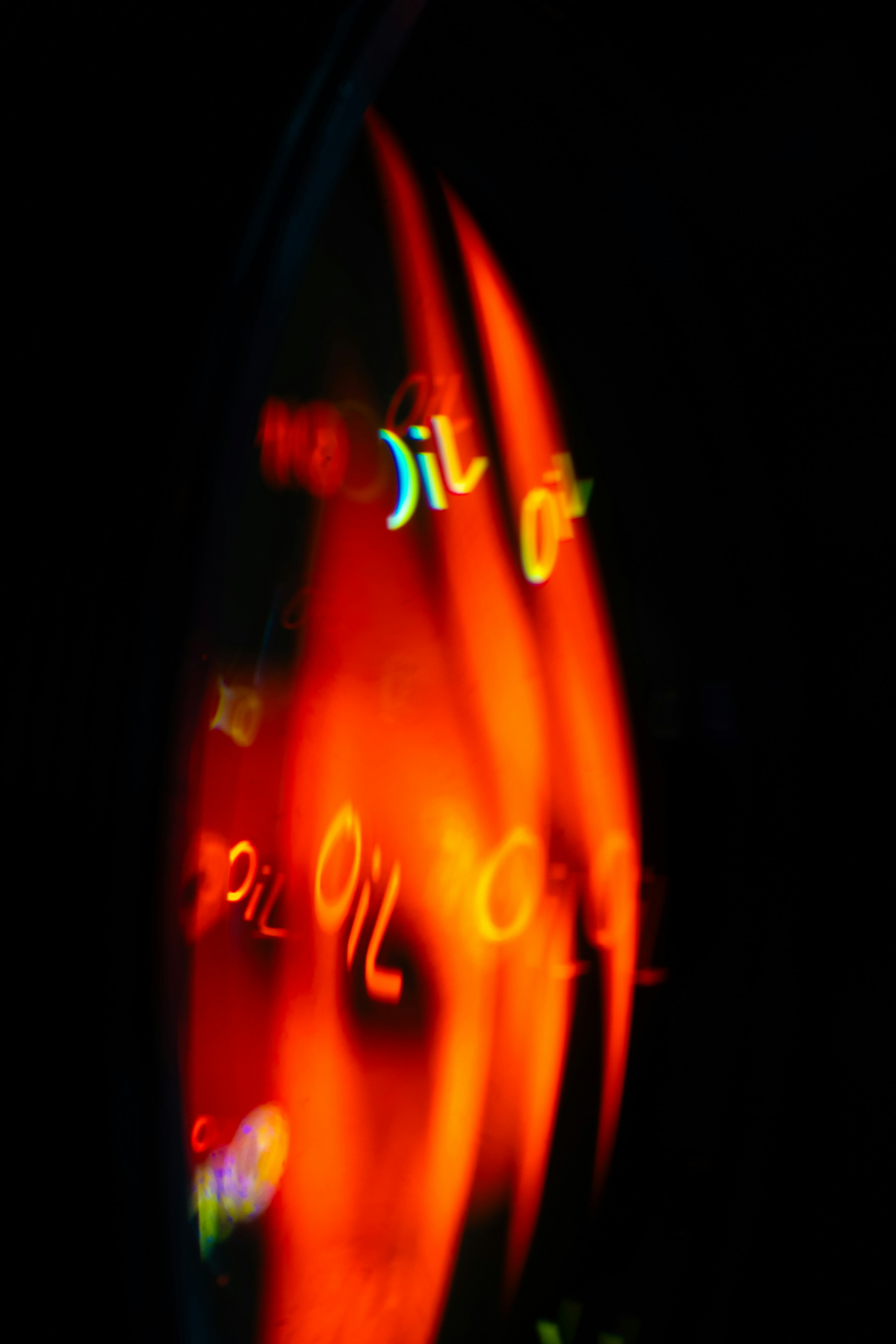 Abstract fiery orange swirls with the word "oil" repeated.