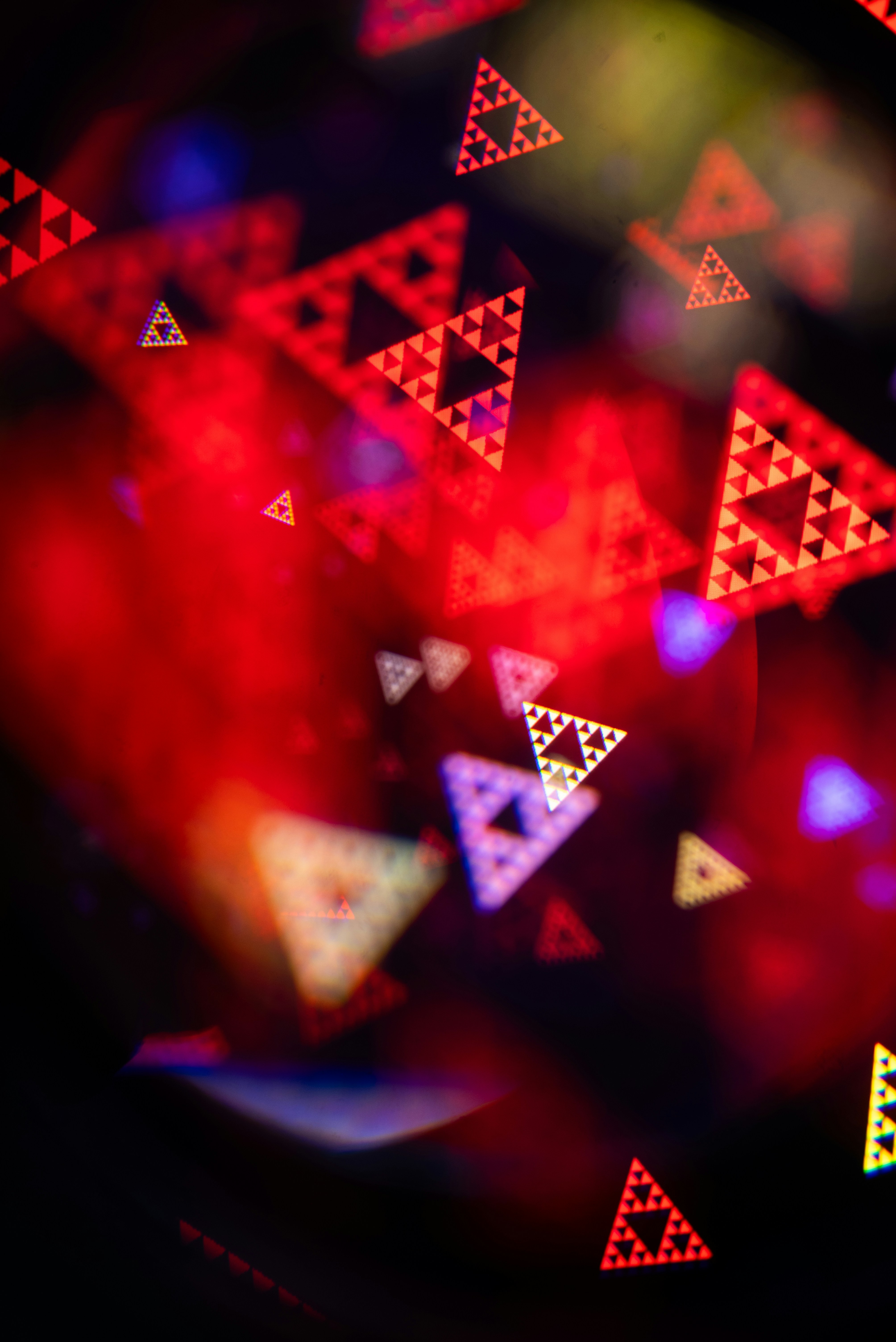 Abstract red triangles with fractal patterns and bokeh lights