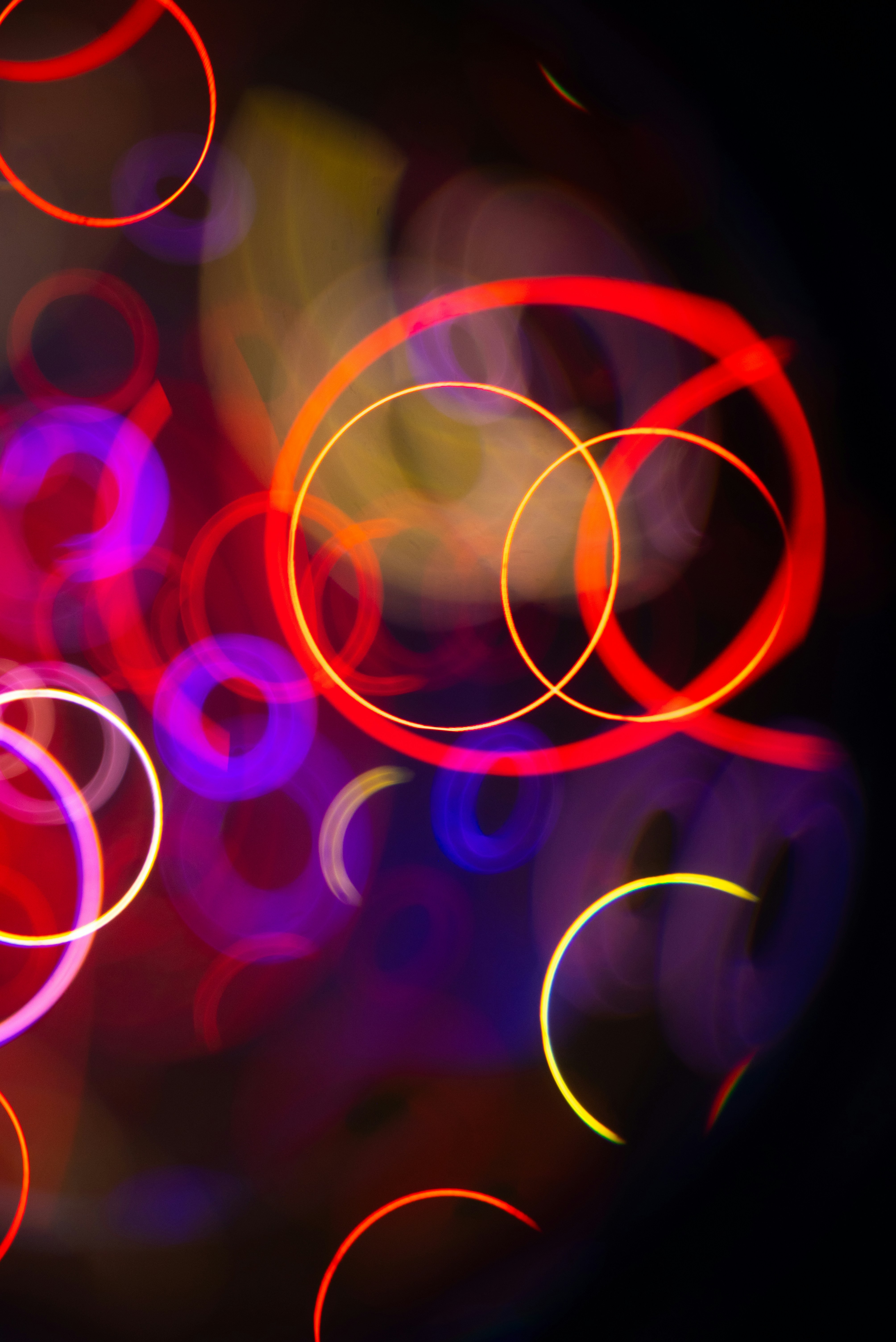 Abstract glowing colorful circles on black background