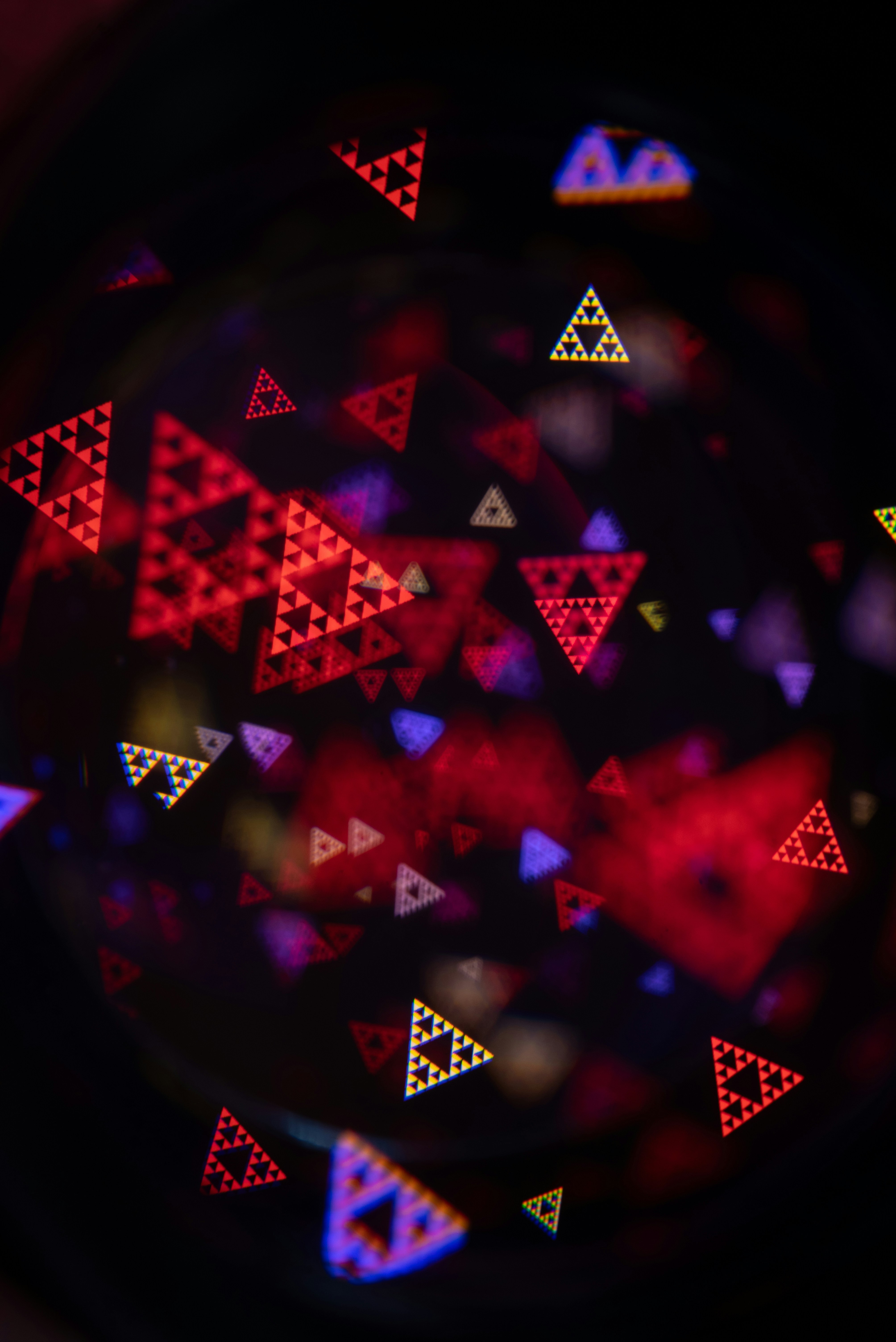 Abstract triangles of red, yellow, and blue light
