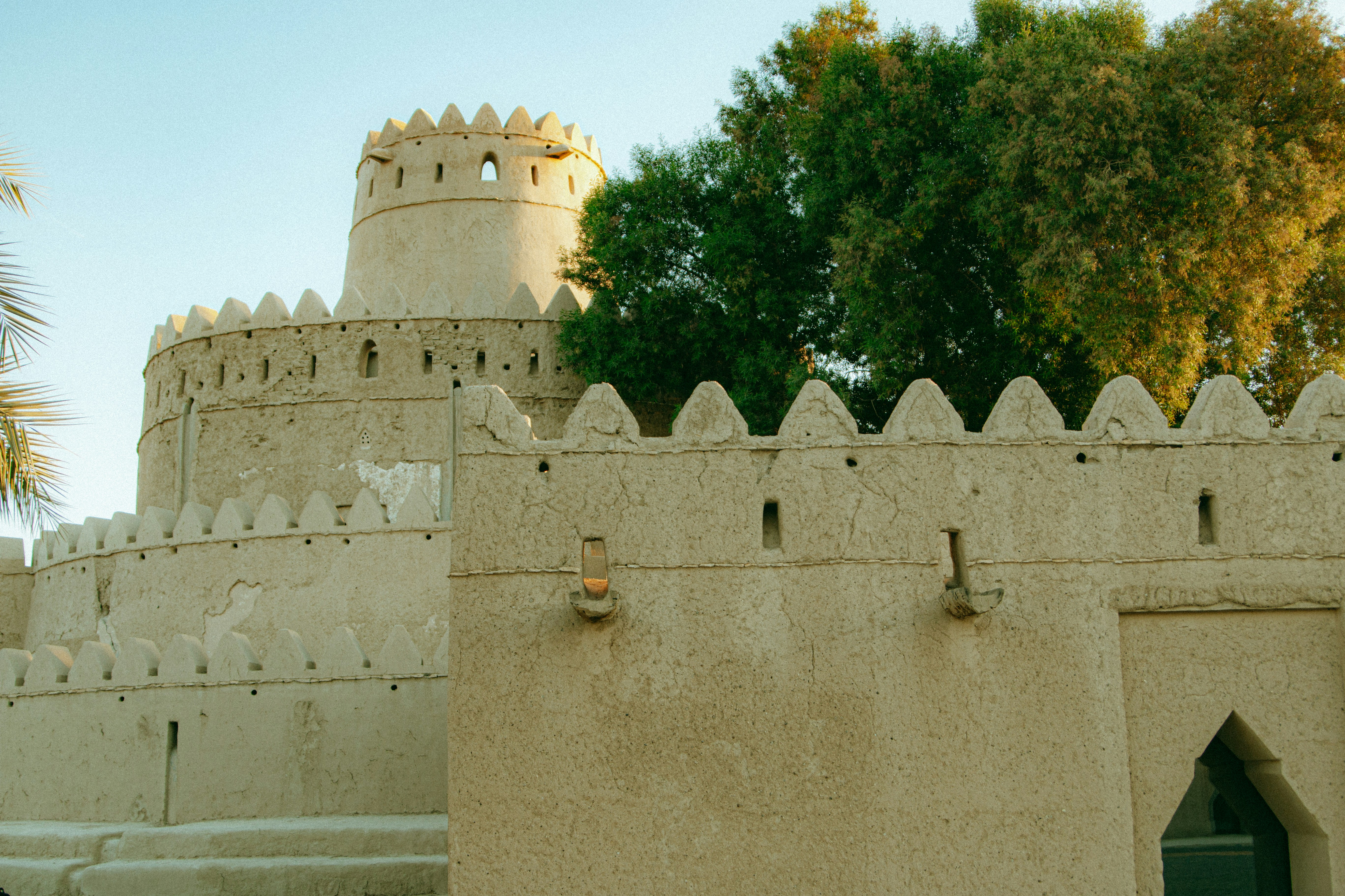 Ancient mud-brick fort with crenellated walls and towers.