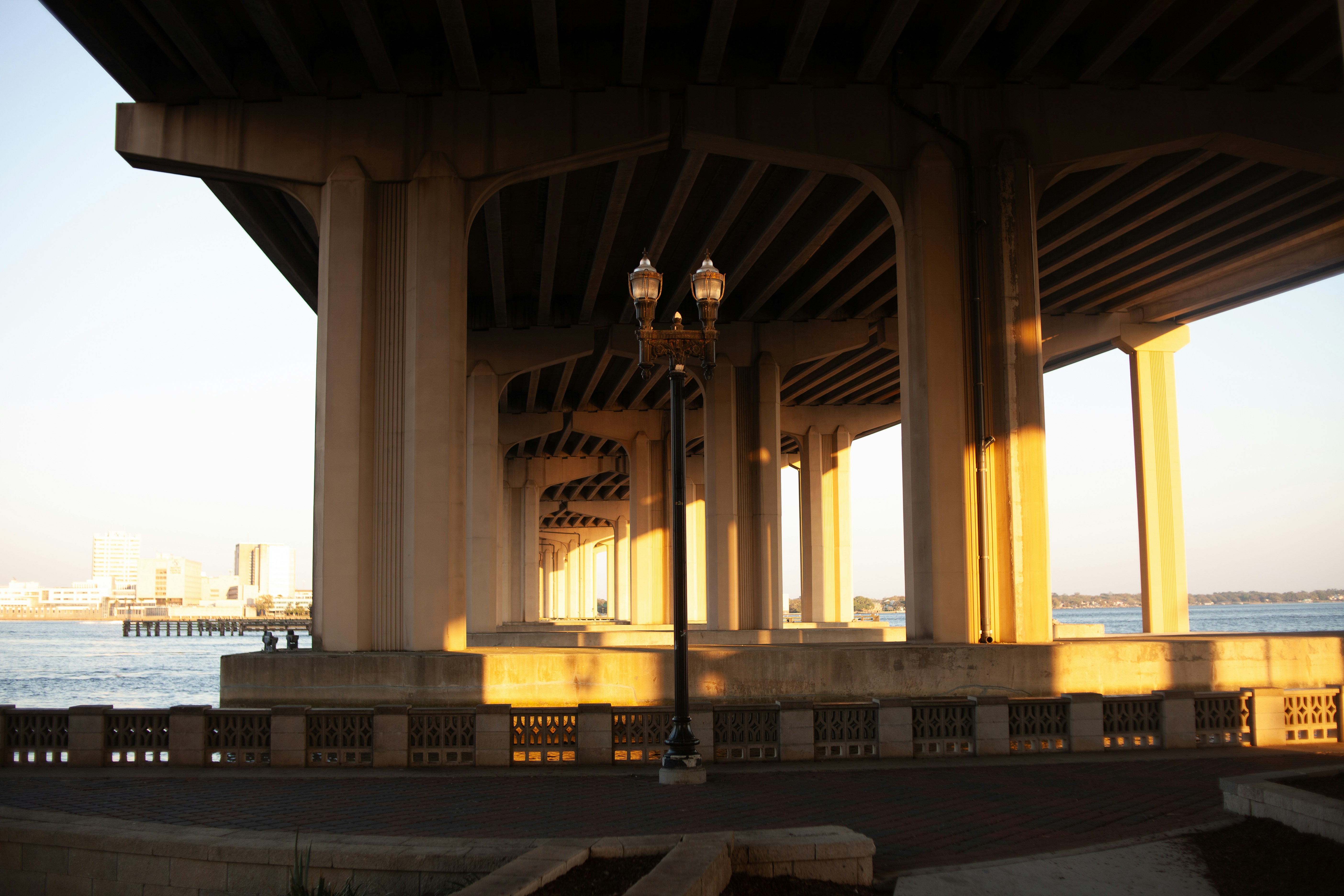 Underneath a concrete bridge with golden hour lighting