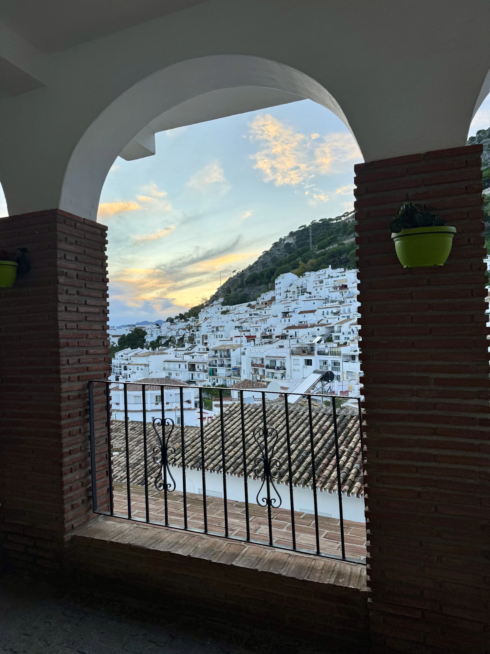 Whitewashed Andalusian village nestled on a hillside at sunset
