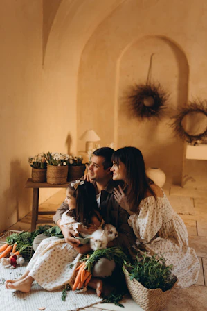 Family with rabbit and vegetables in rustic setting