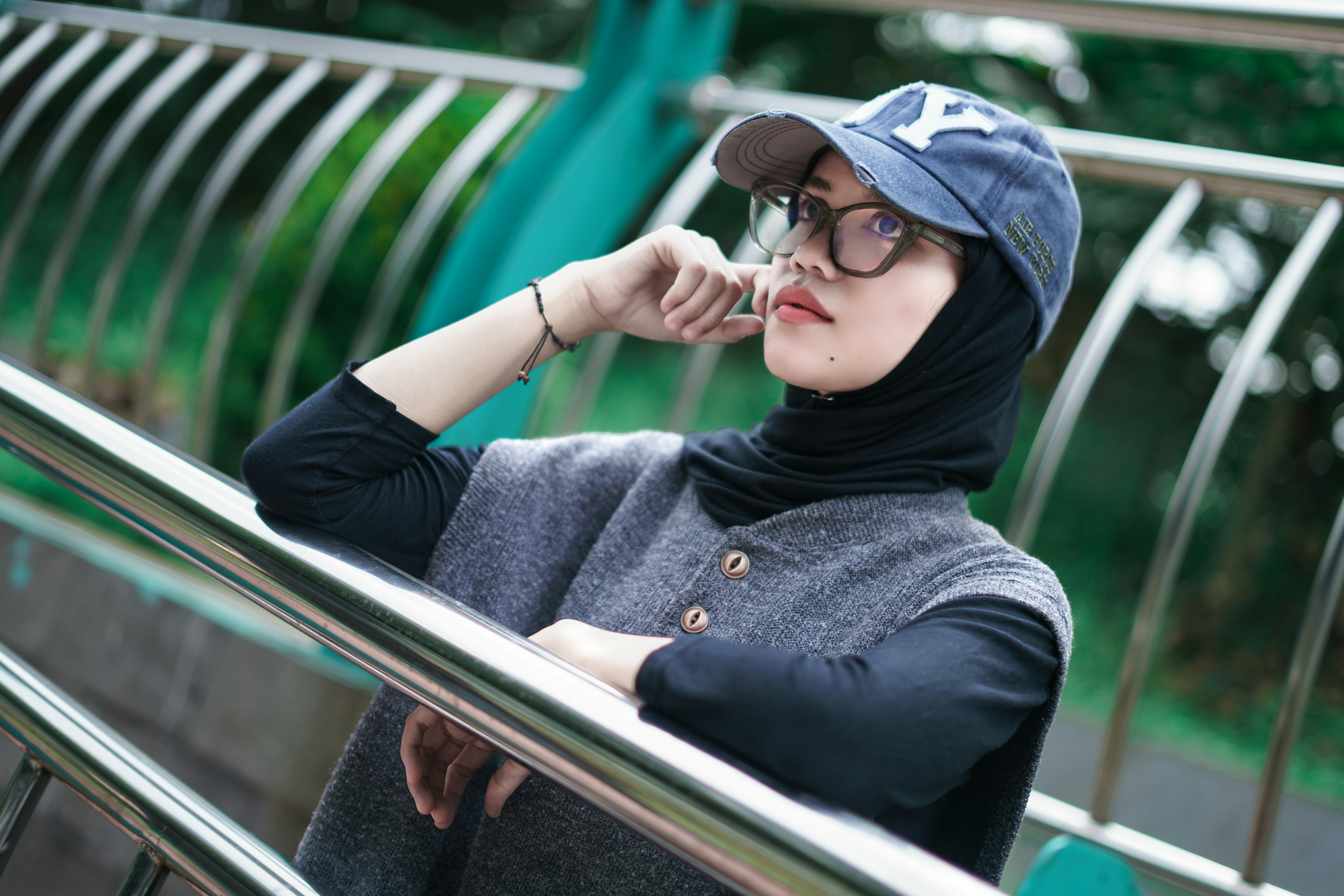 Woman wearing a hijab and baseball cap outdoors