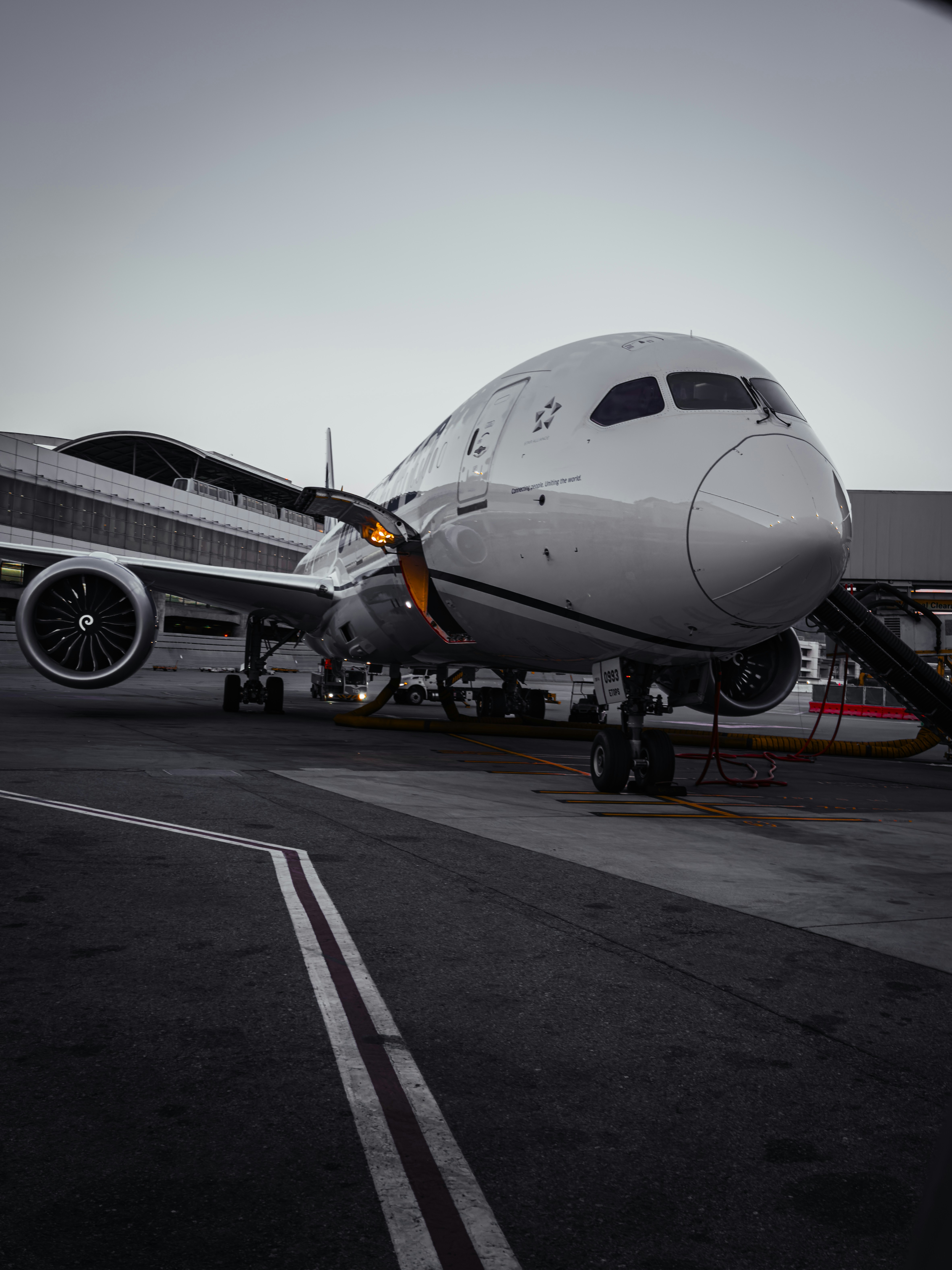 A modern jet airplane parked at an airport gate.