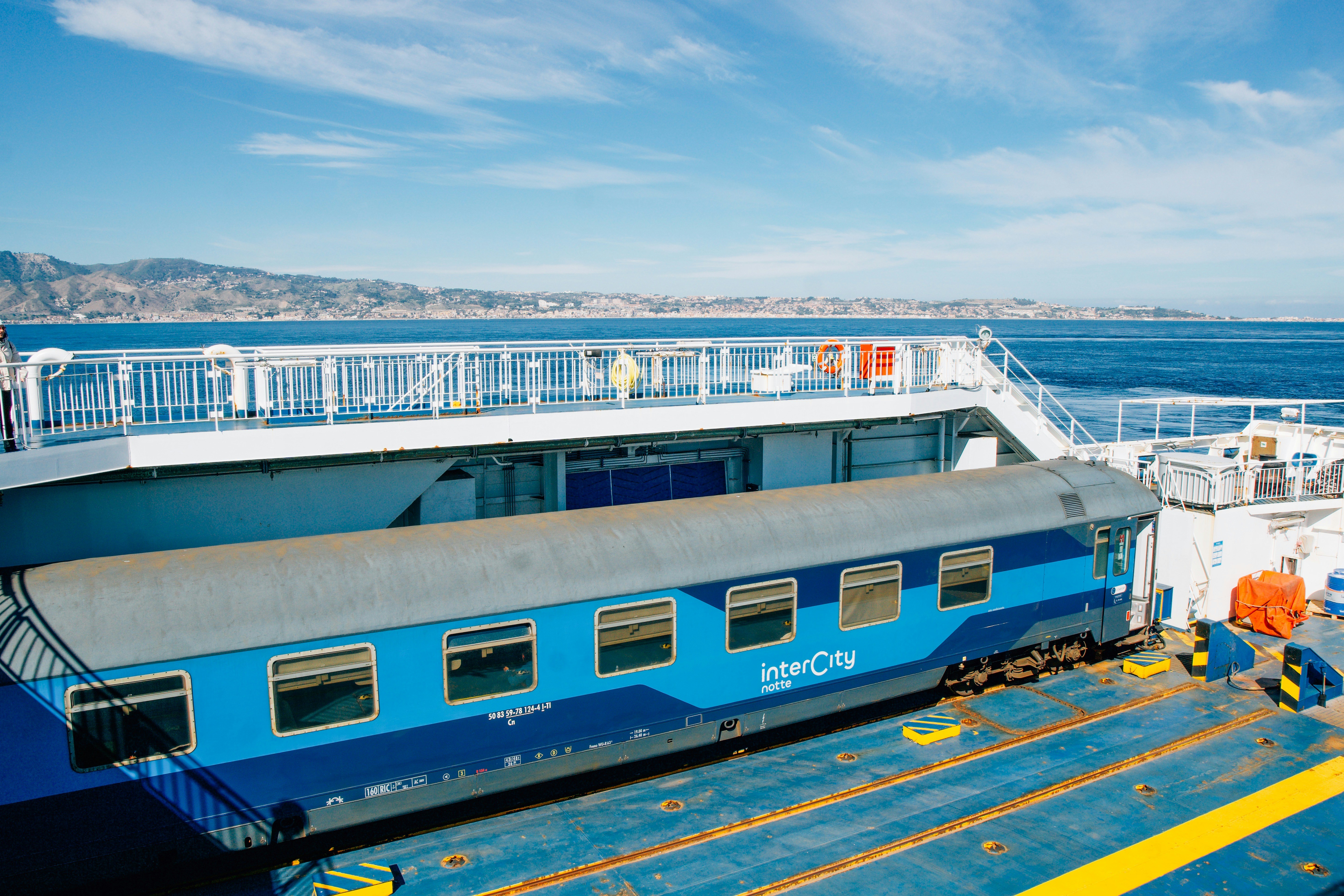 A blue intercity train carriage on a ferry