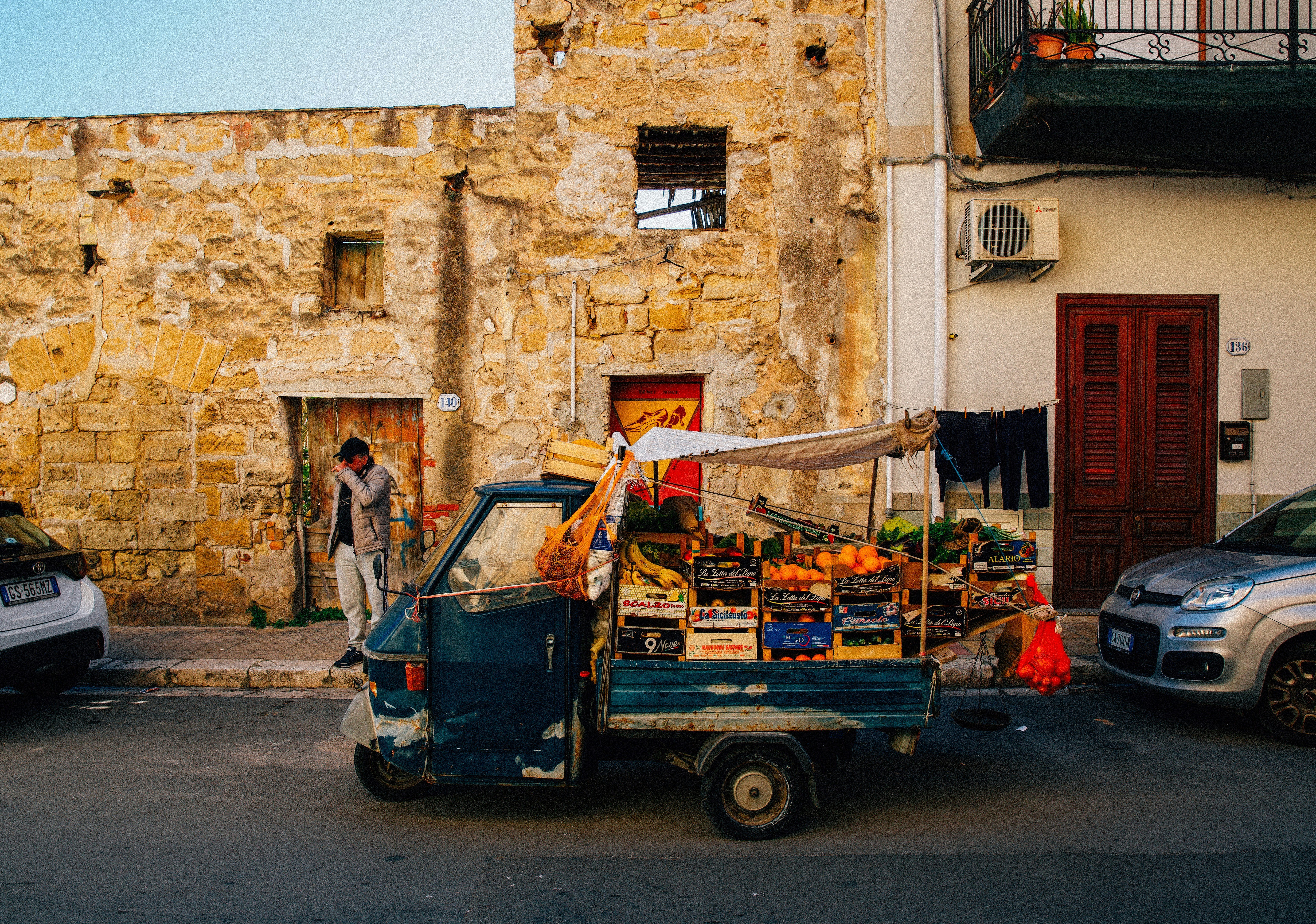 A small truck selling fruit on a street.