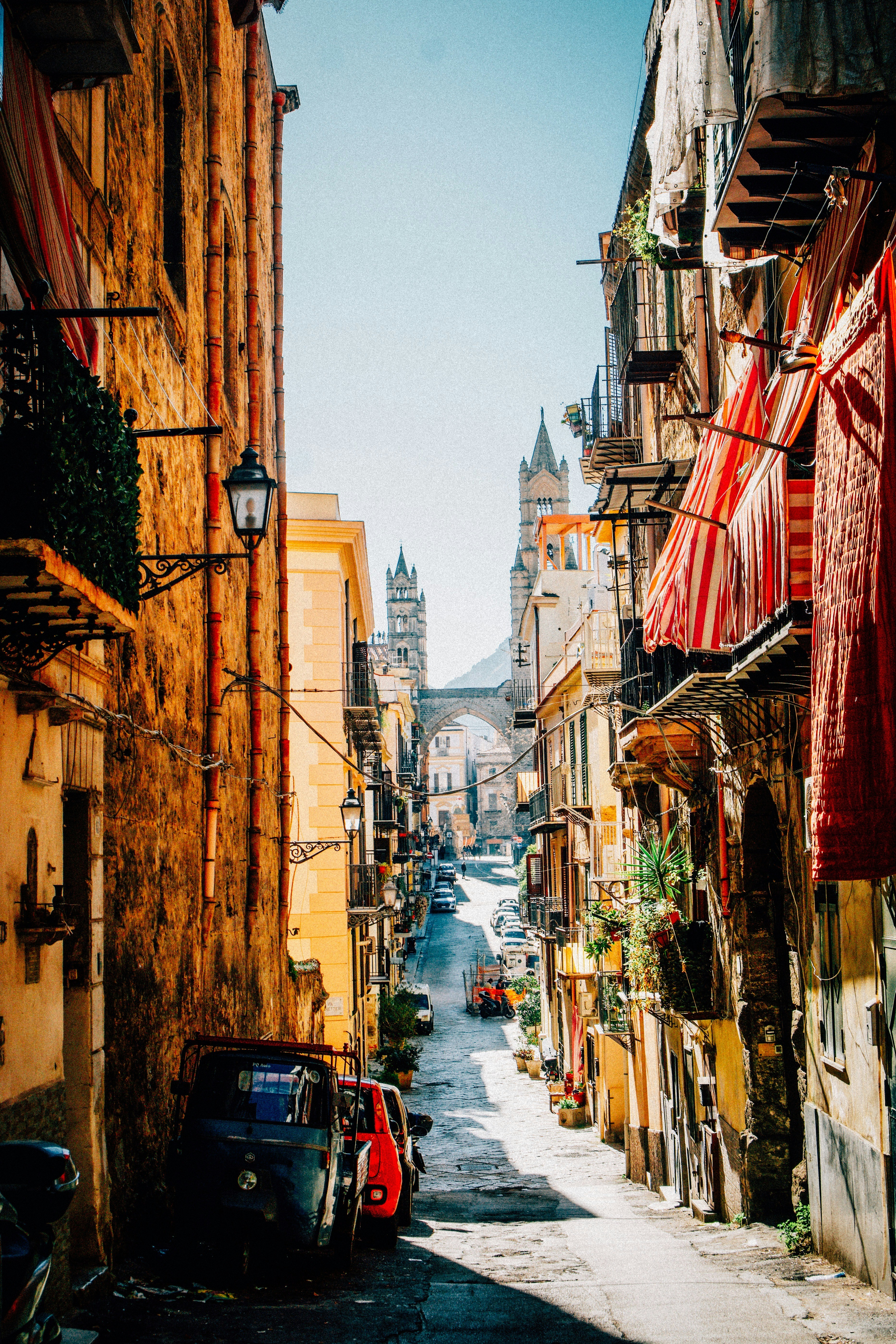 Narrow european street with buildings and cars