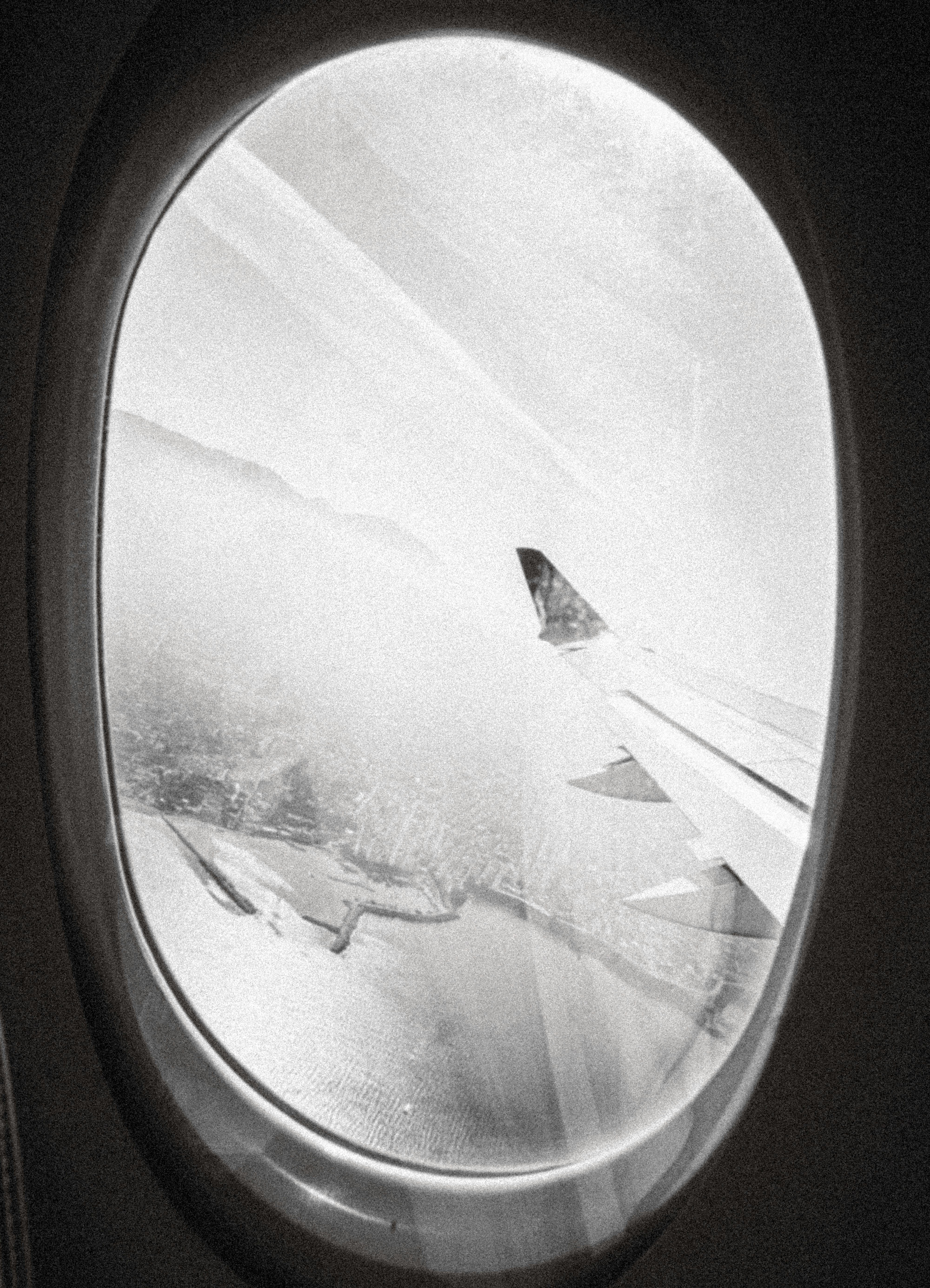 View from airplane window of wing and clouds
