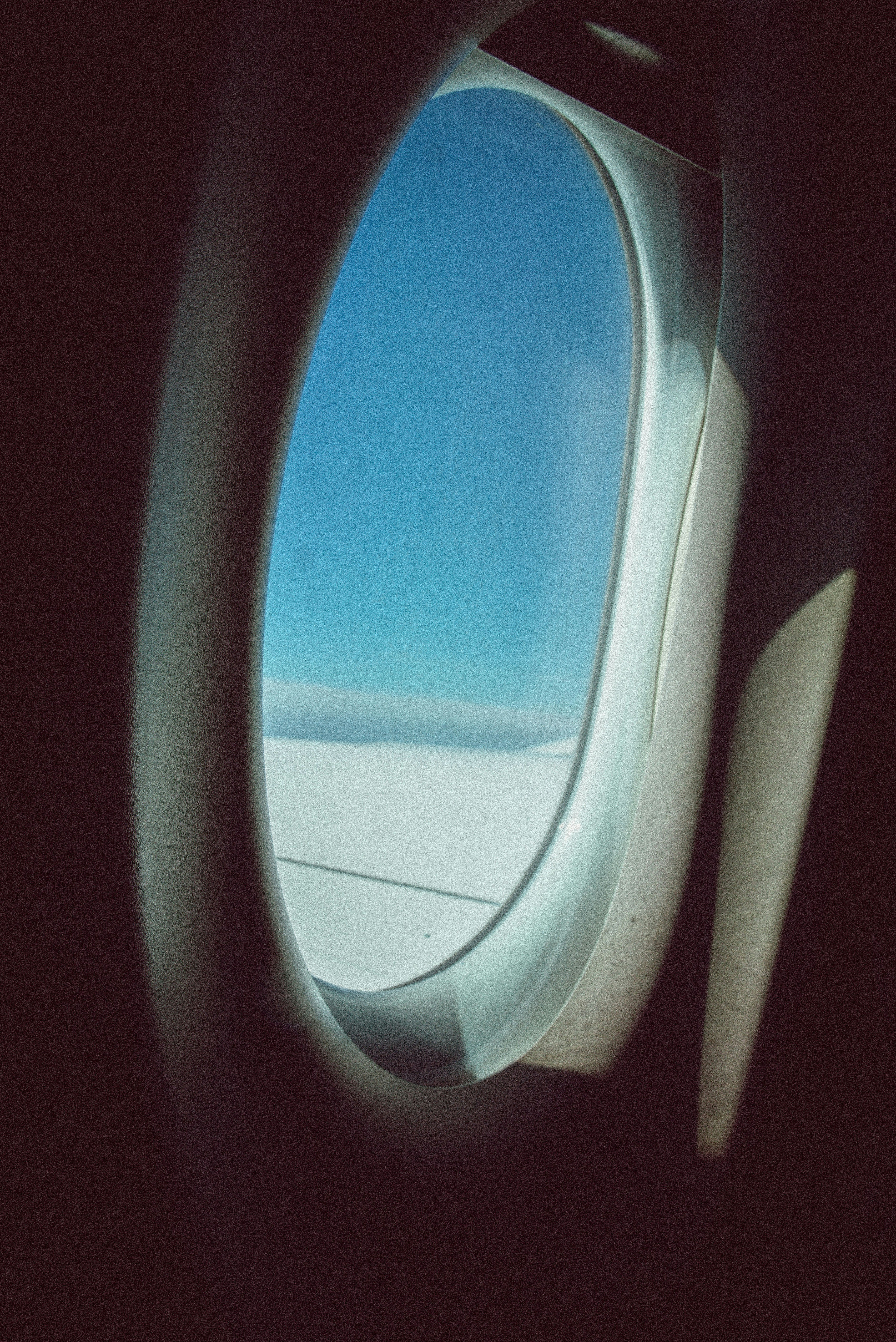 View of blue sky and clouds from airplane window