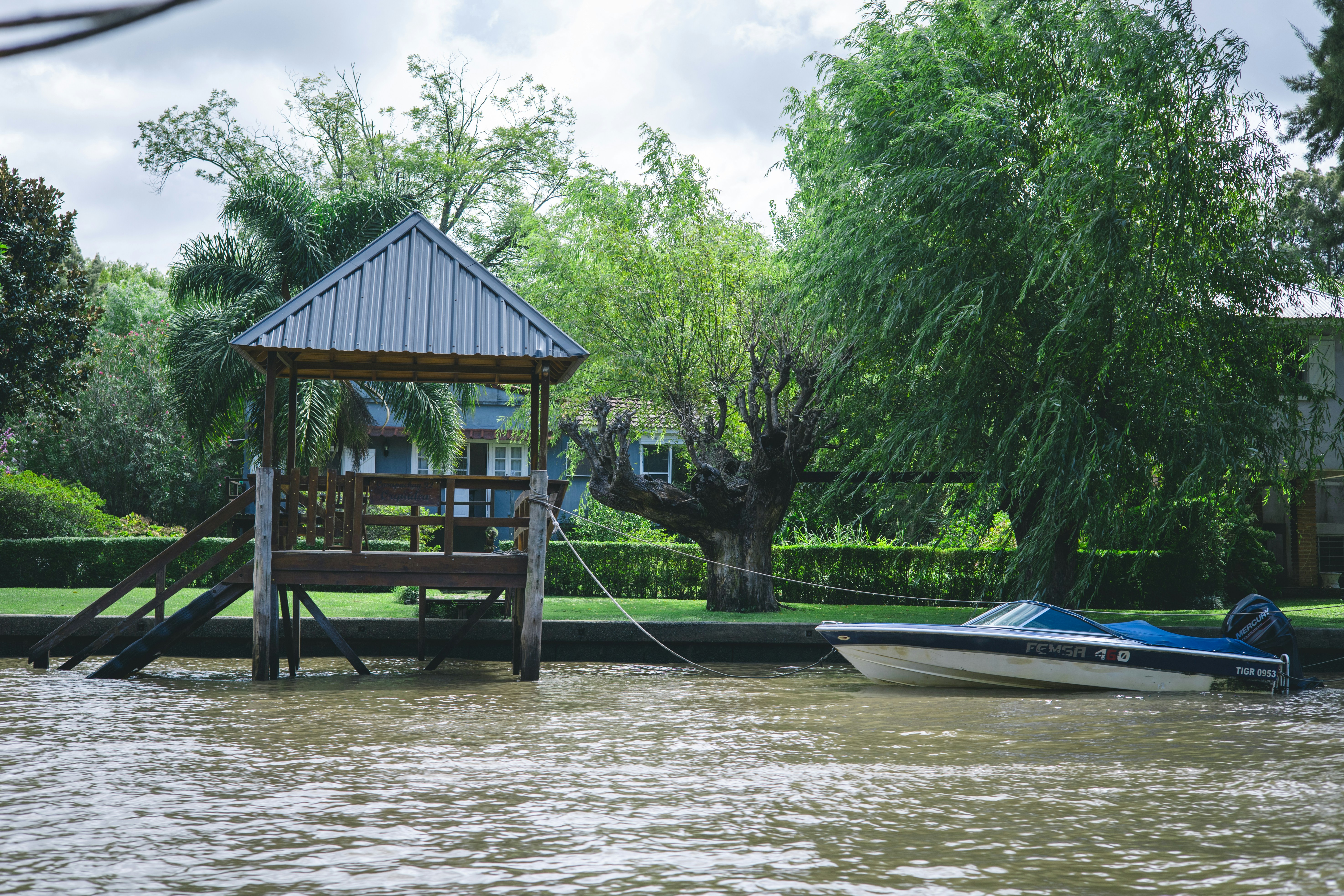 Boat docked by a wooden pier next to trees photo – Free Travel Image on ...