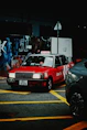 Red taxi with uber taxi logo on street at night