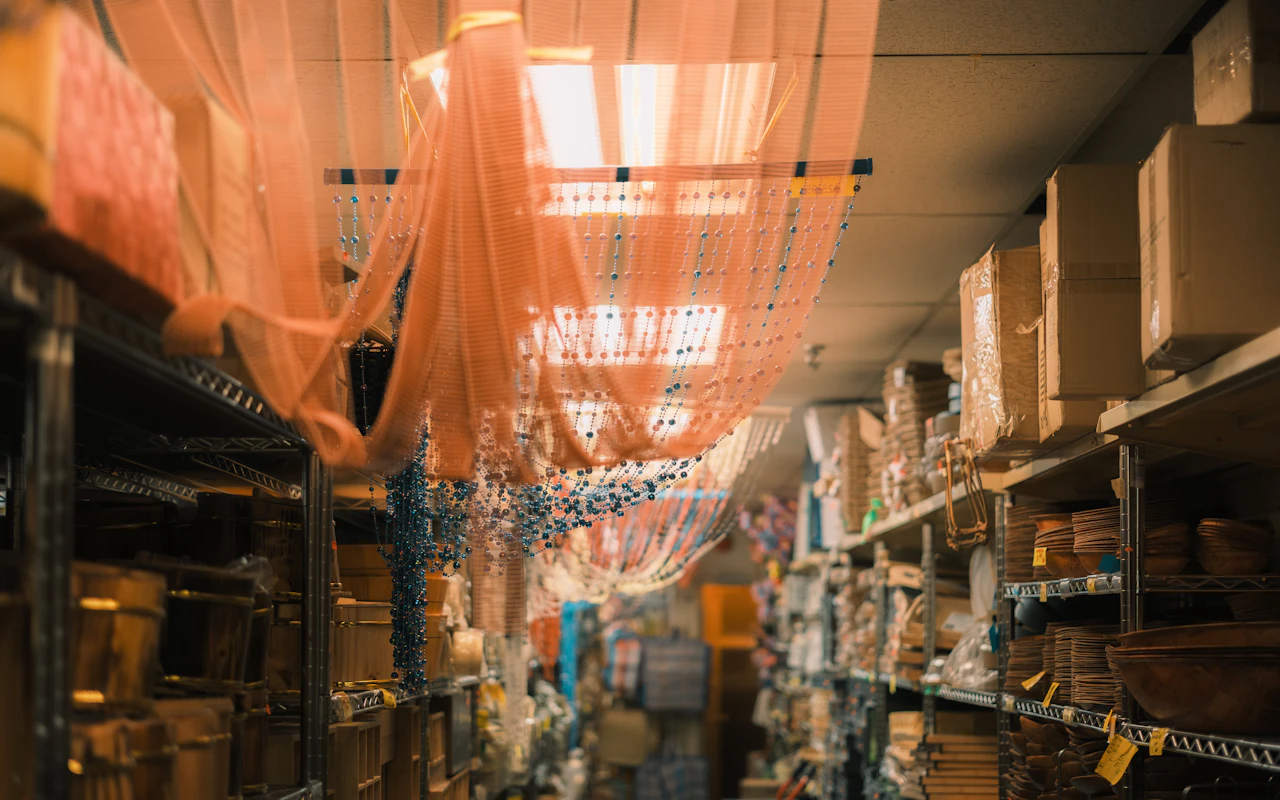 Crowded stockroom shelving packed with unsold merchandise, the working capital slow sell-through quietly ties up