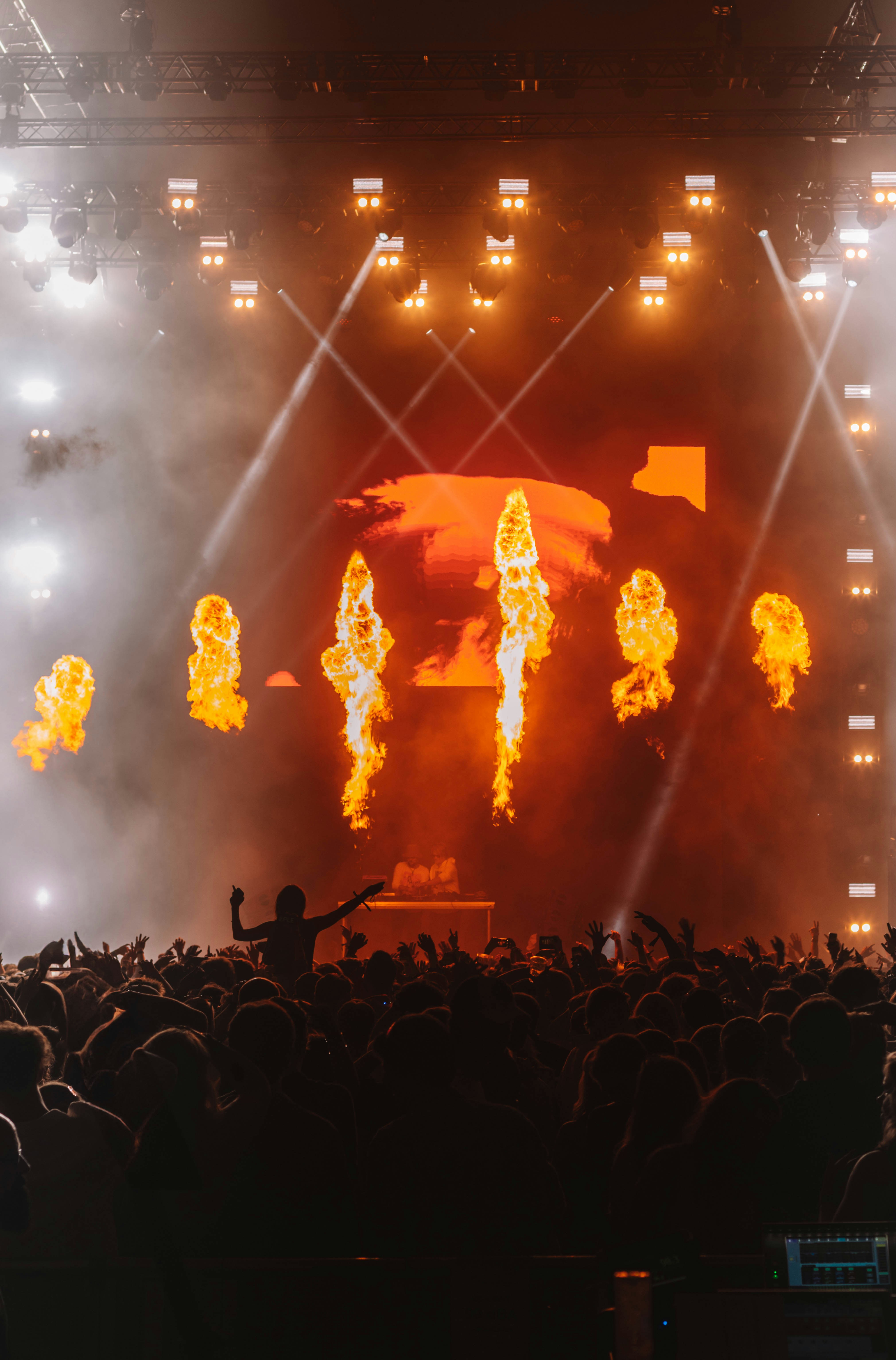Concert crowd with flames and lights on stage