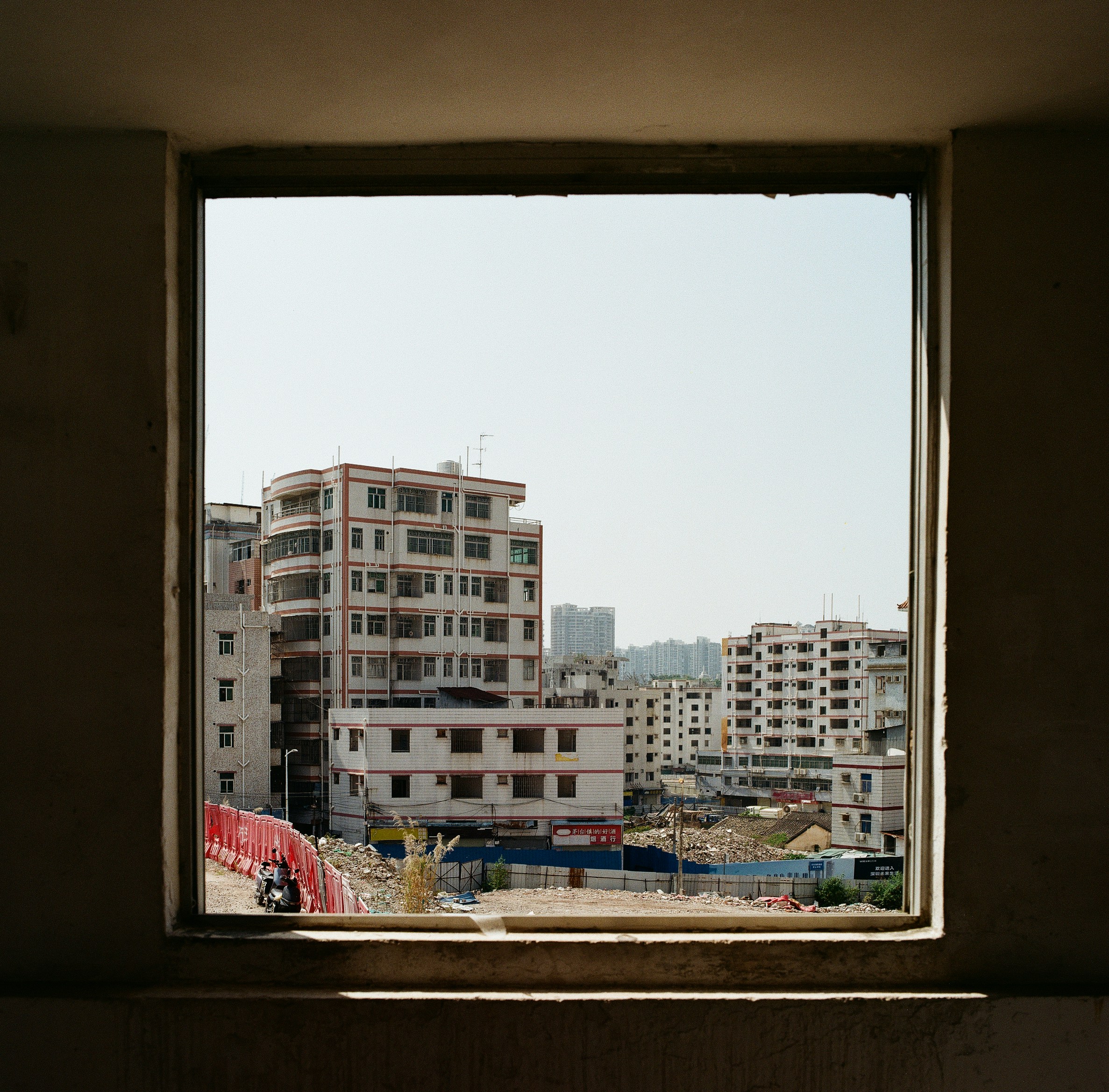 Blick auf Gebäude durch einen Fensterrahmen.