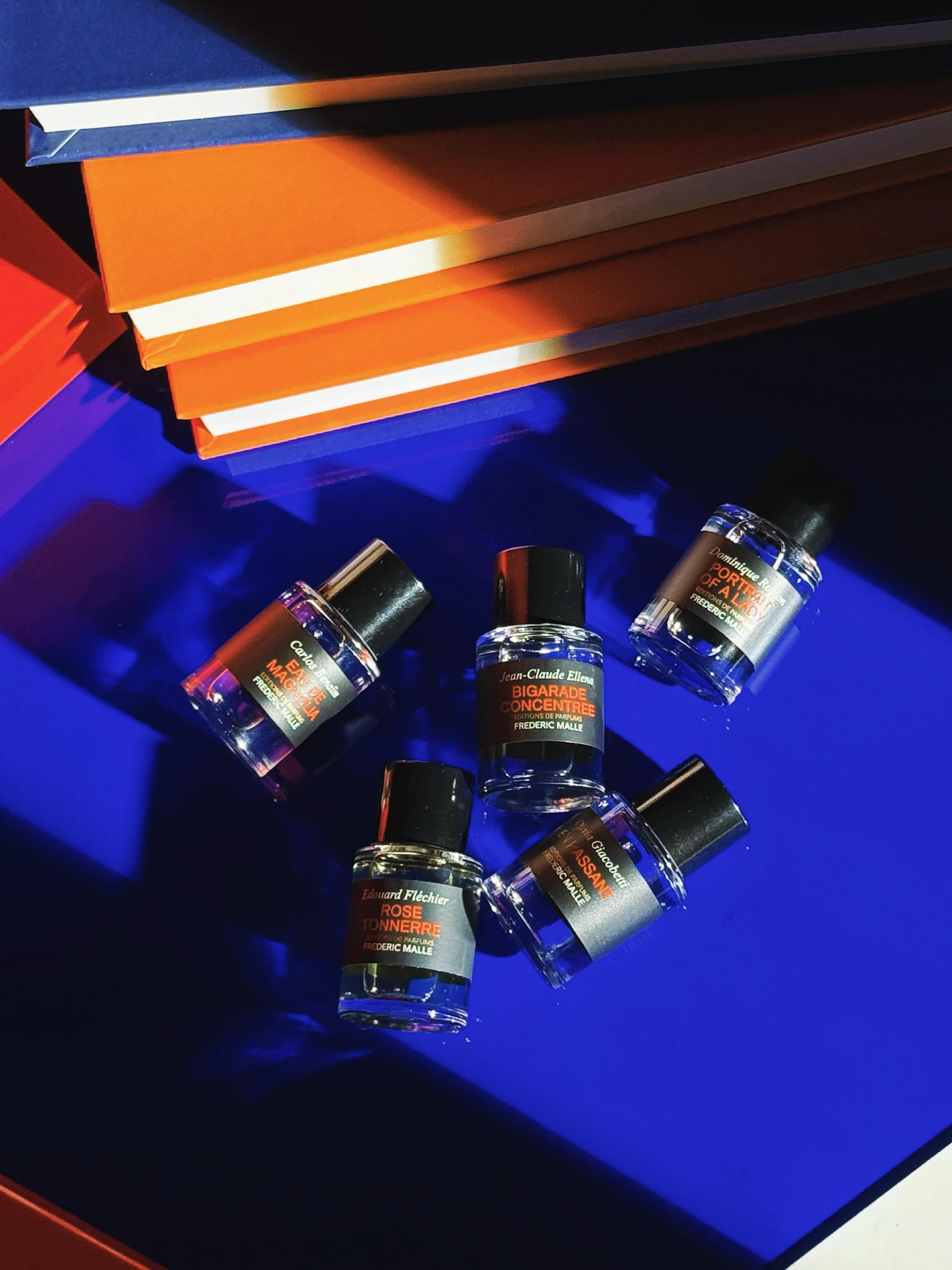 Best summer perfumes for women arranged on a soft blue surface