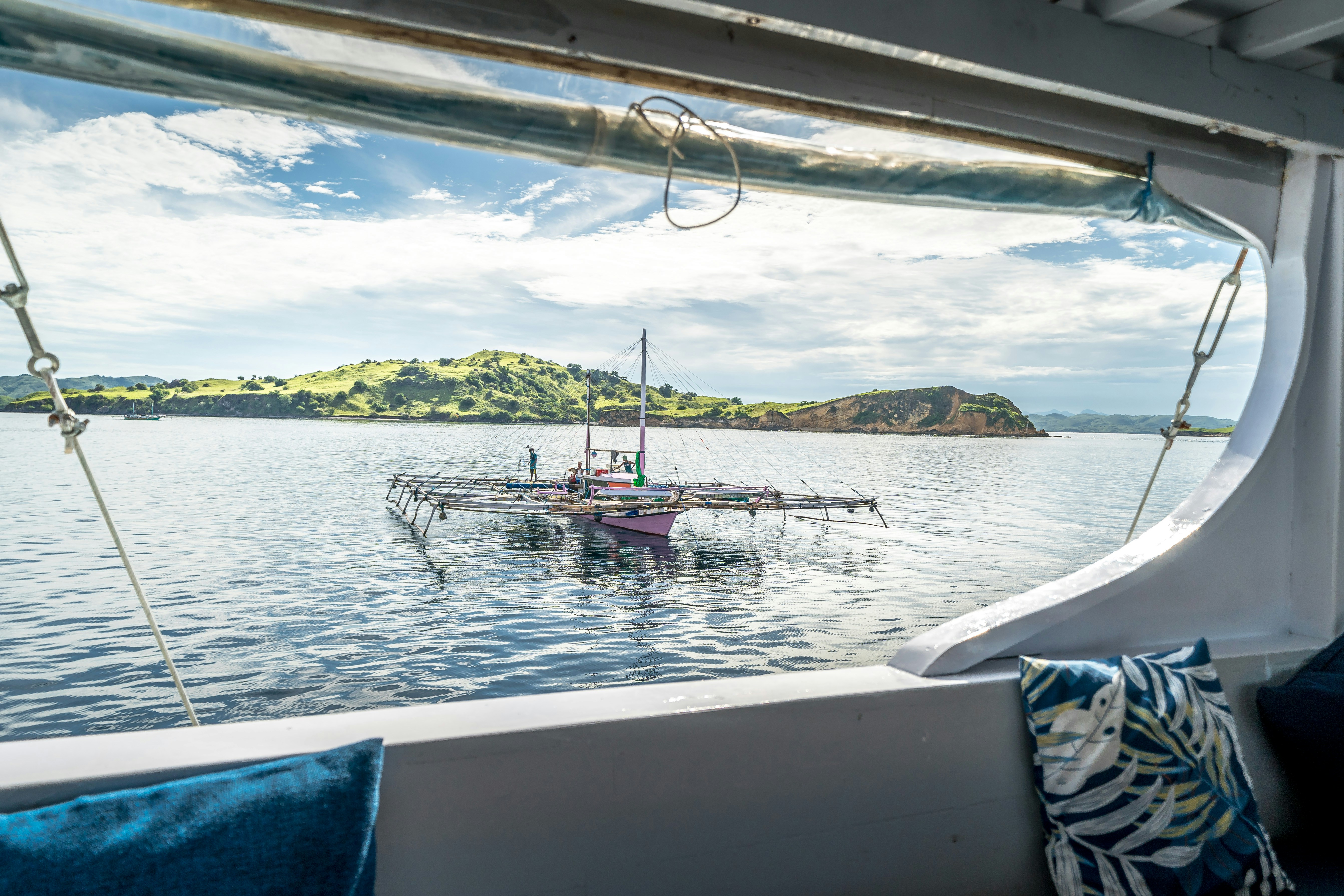 Boat with a large net structure on the water.