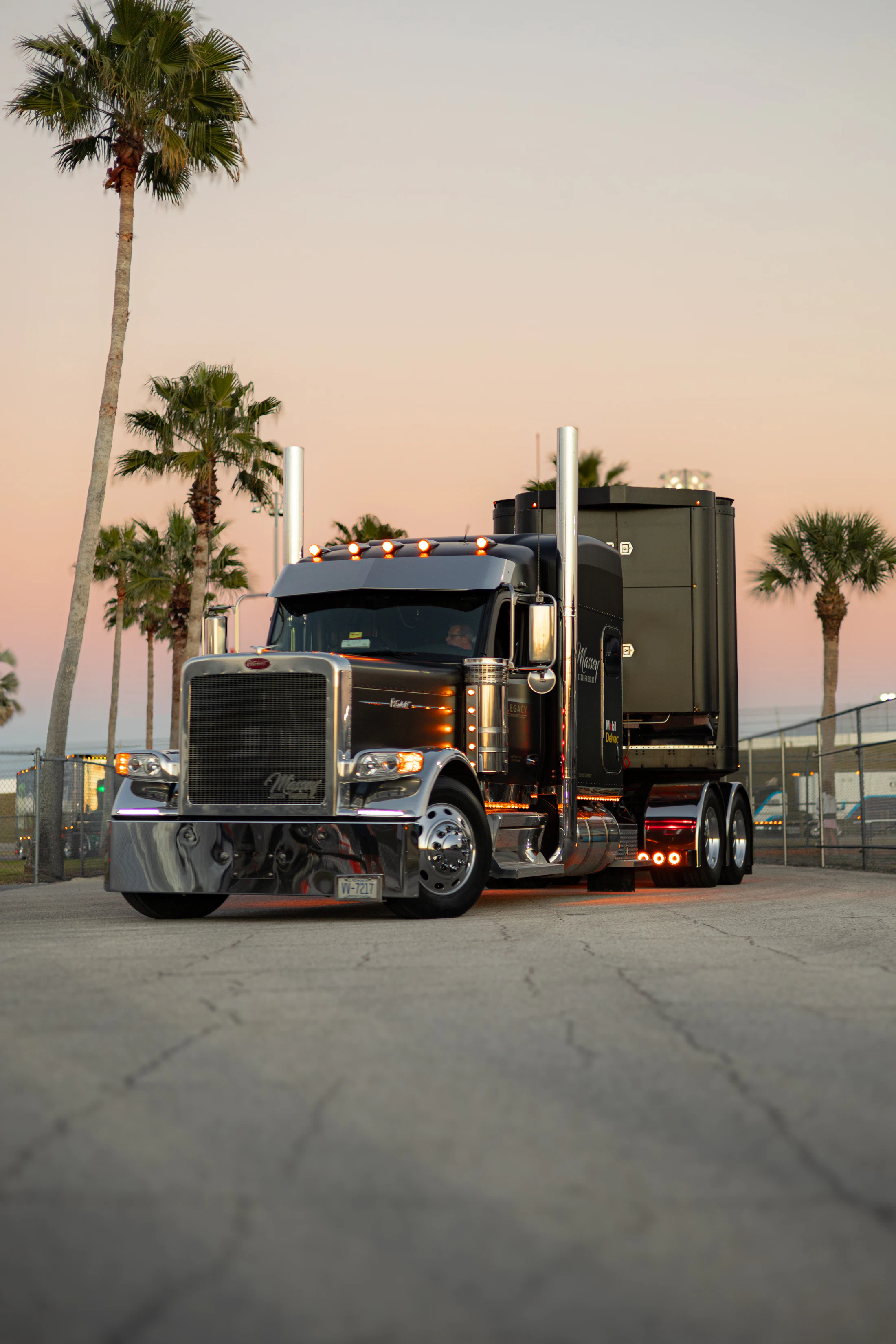 Black semi truck at sunset