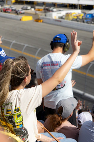 Spectators watch a race from stadium seating.