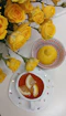 Yellow roses beside tea with lemon slices