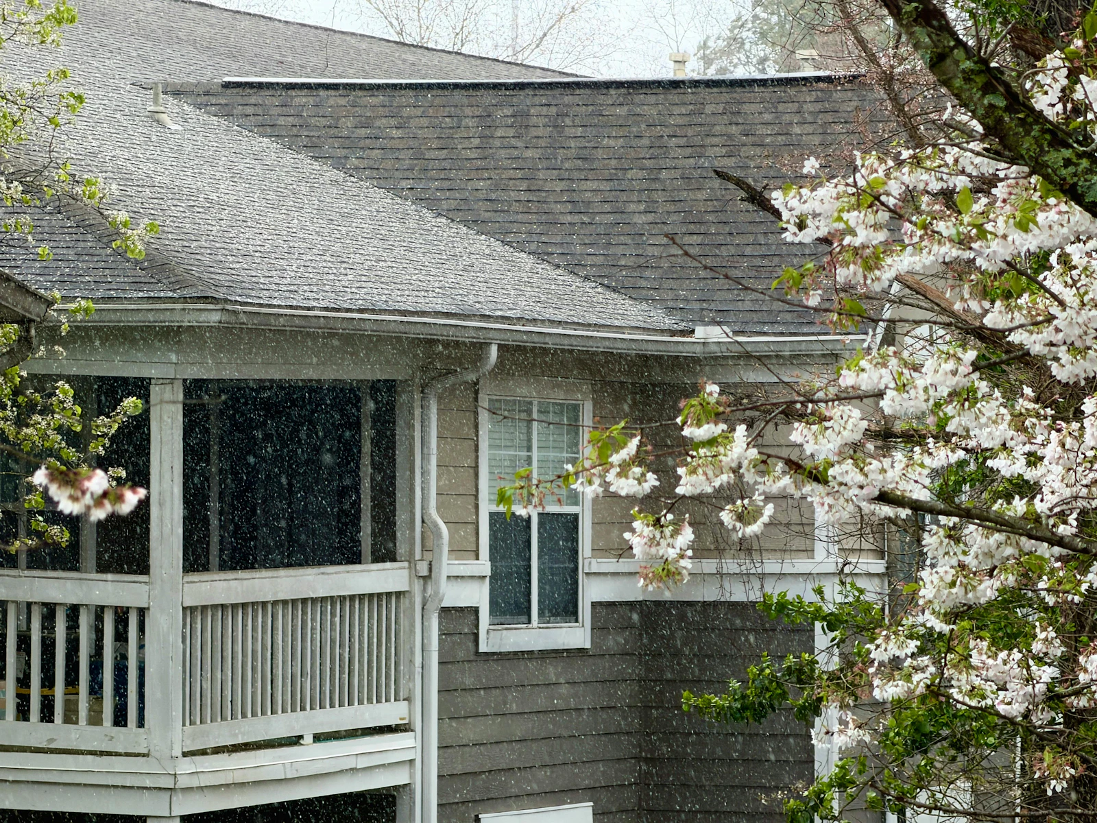 House with gutters and a covered porch in the rain