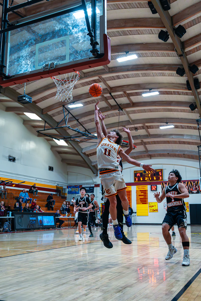 Basketball players jump for a shot during a game