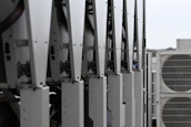 Row of white hvac units on a rooftop