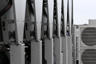 Row of white hvac units on a rooftop