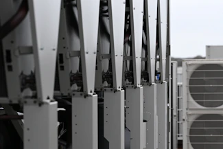 Row of white hvac units on a rooftop
