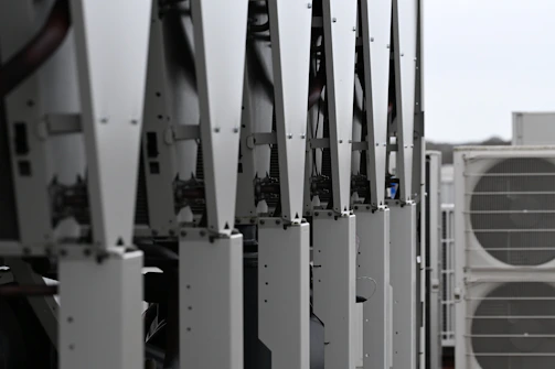 Row of white hvac units on a rooftop