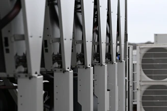 Row of white hvac units on a rooftop