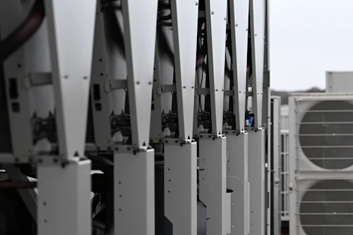 Row of HVAC condenser units on a rooftop