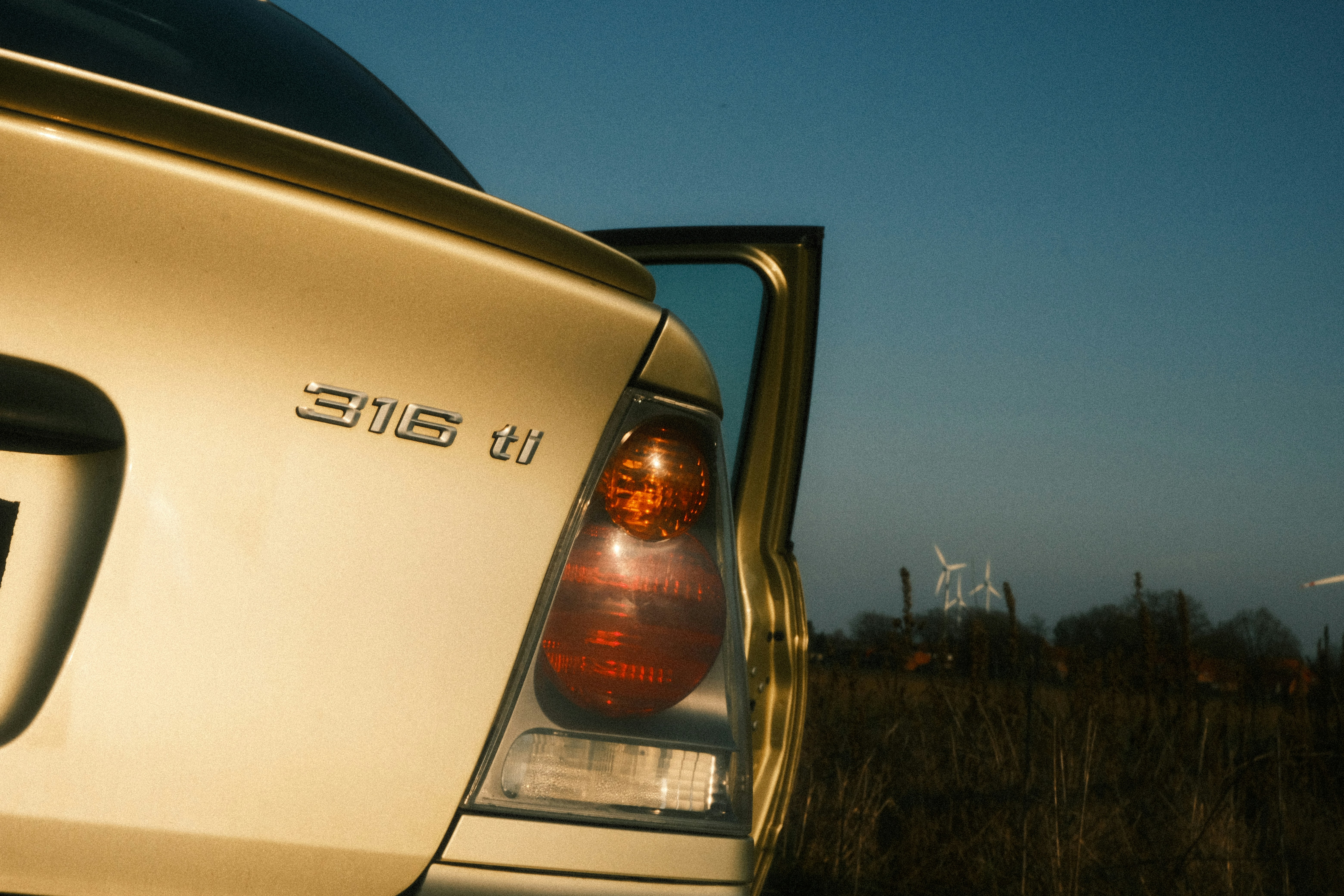 Close-up of a car's taillight with open door