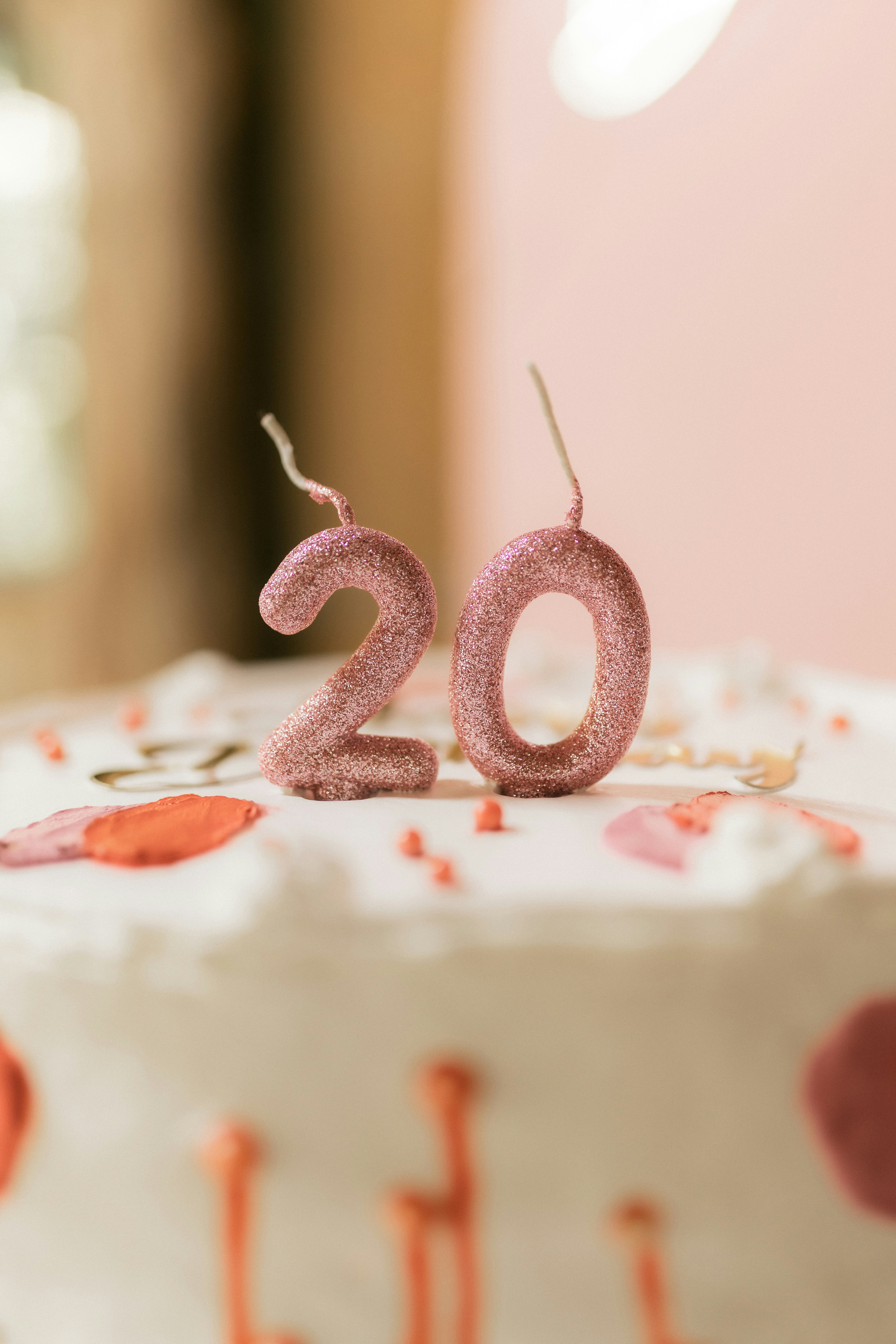 Two pink glitter candles spelling out the number 20.