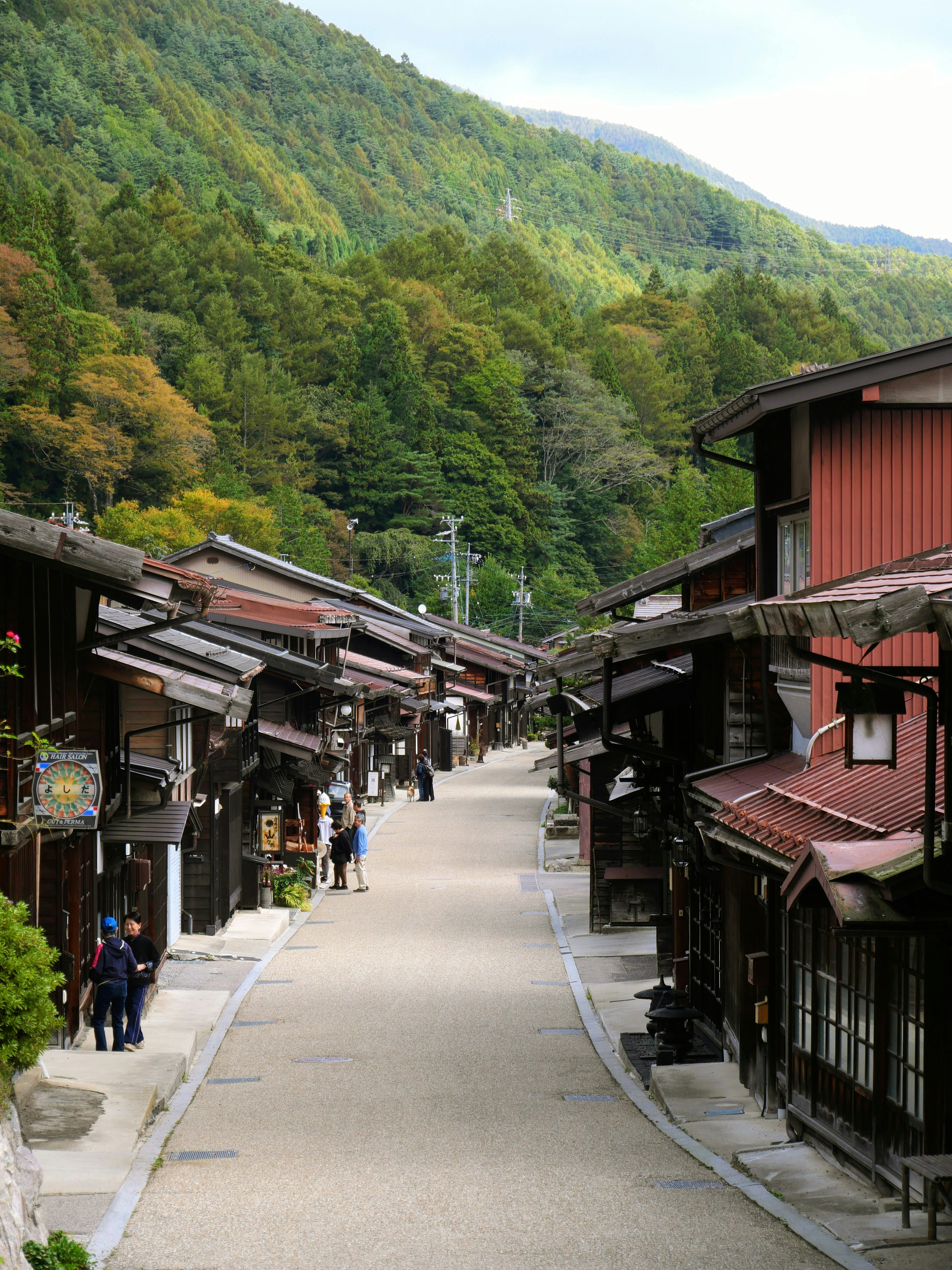 Traditional japanese street lined with old wooden buildings.