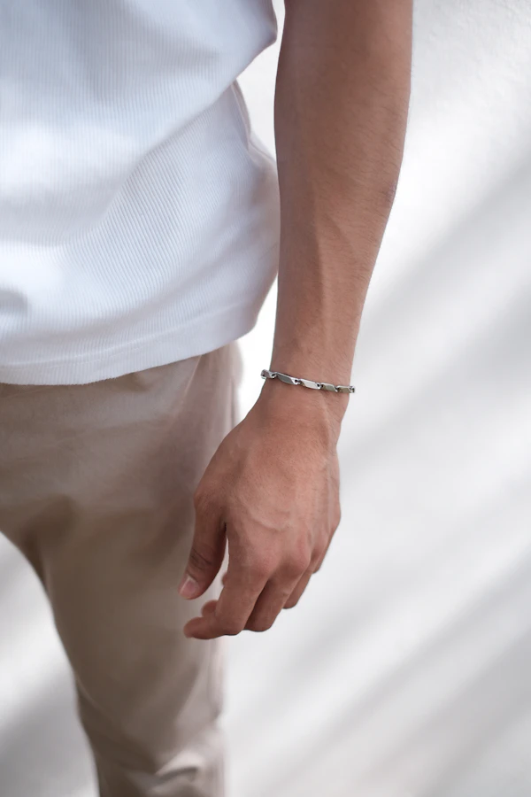Man wearing a slim silver bracelet