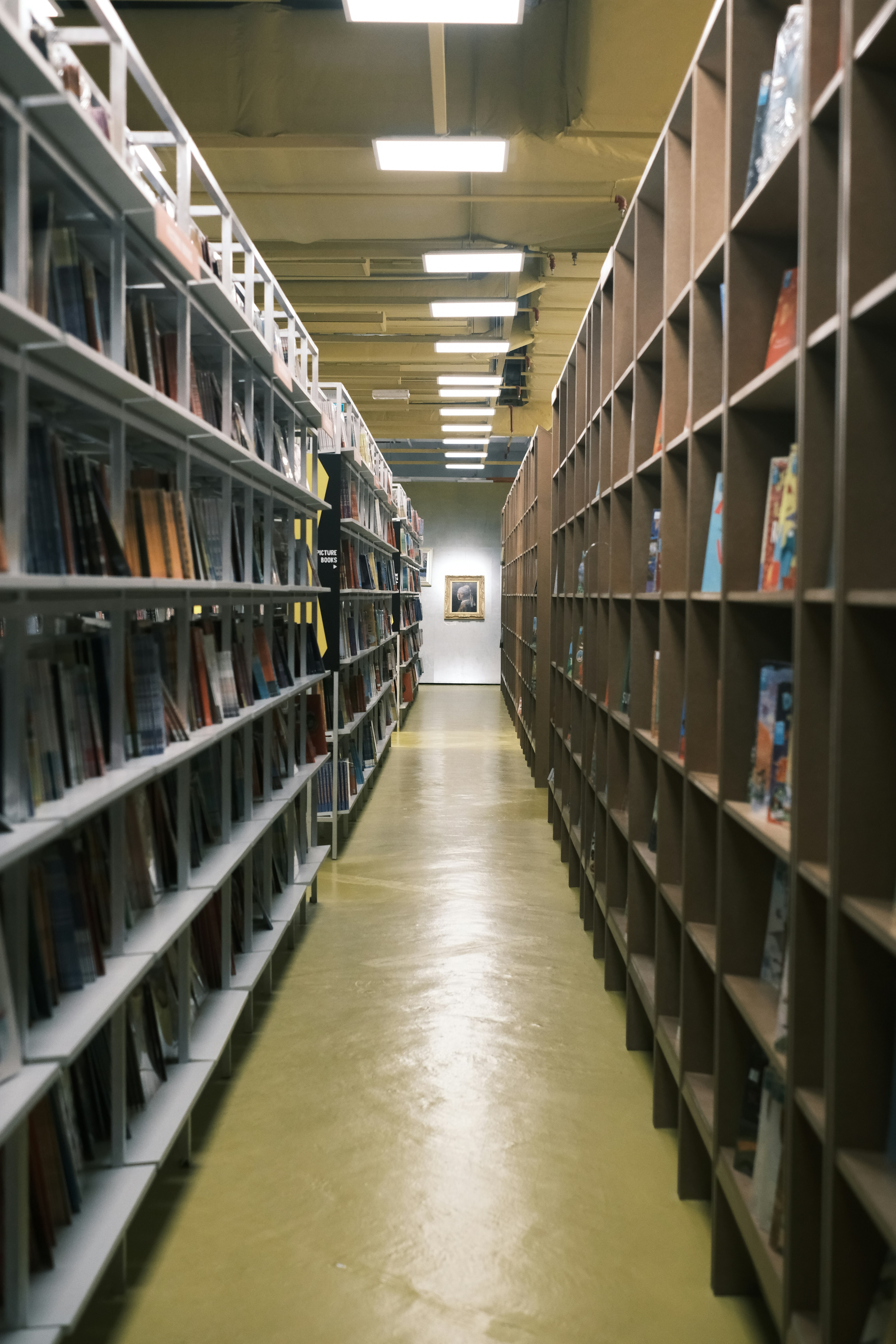 A long hallway lined with bookshelves in a library.
