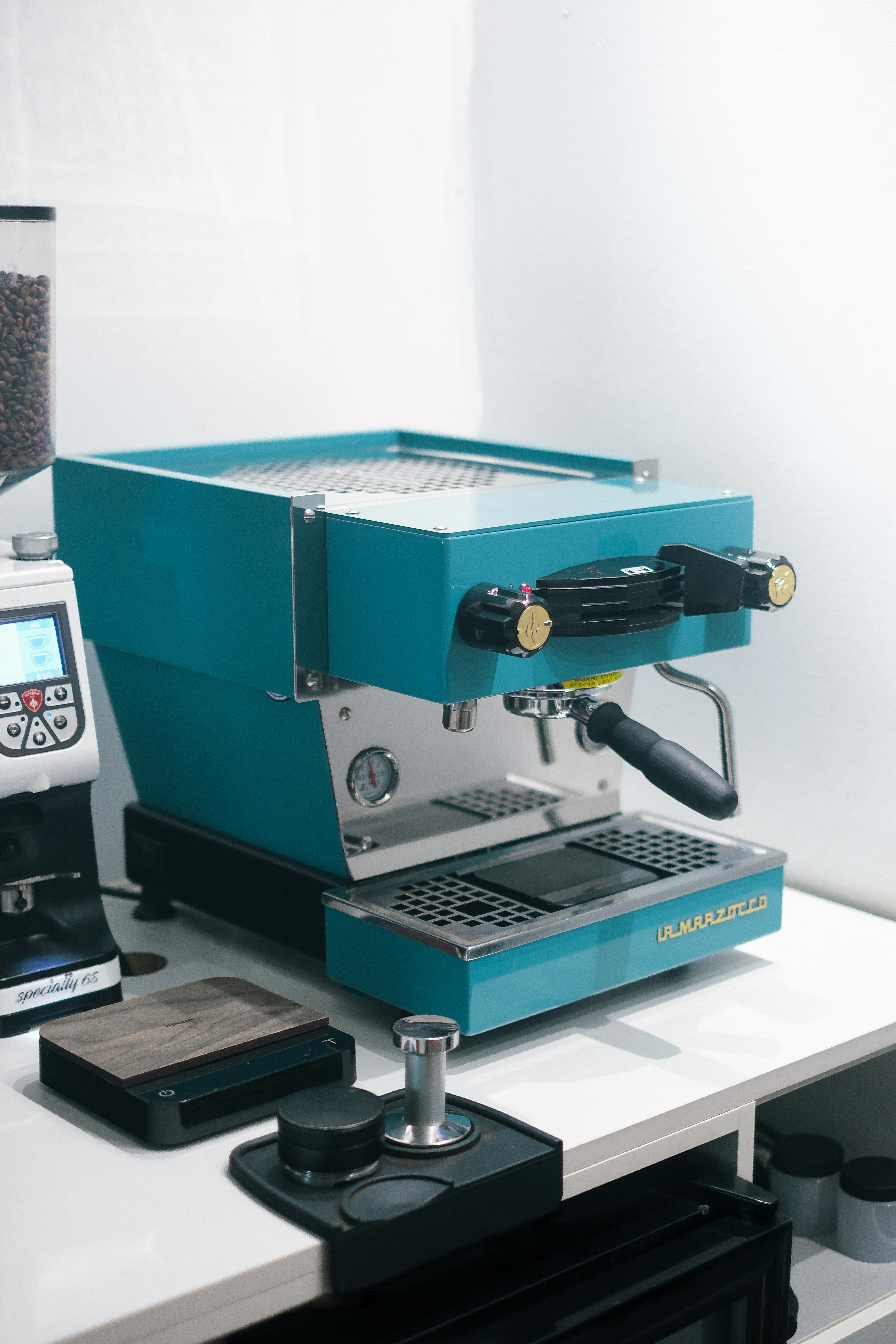 Teal espresso machine with coffee grinder and accessories