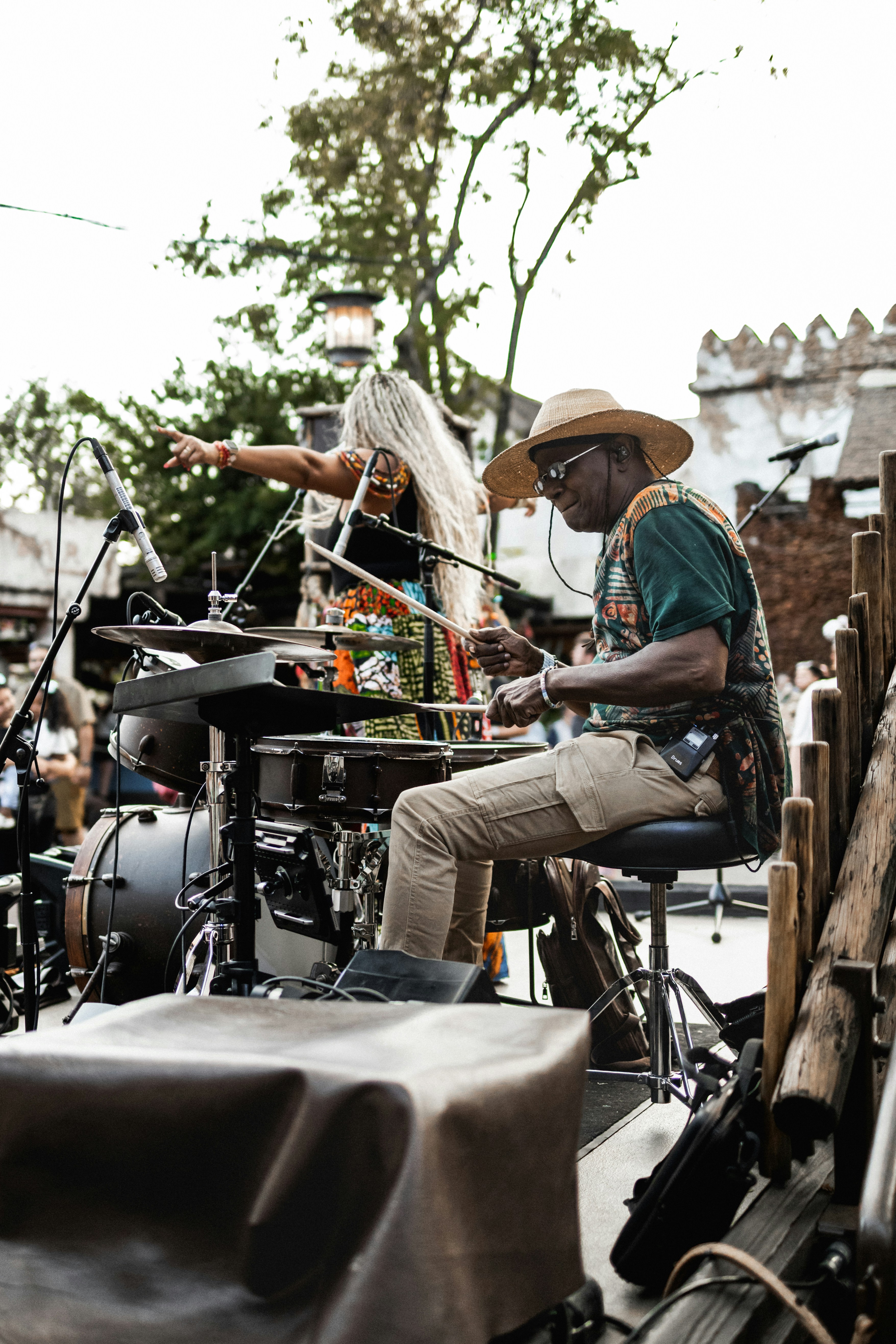 Musicians perform live on an outdoor stage.