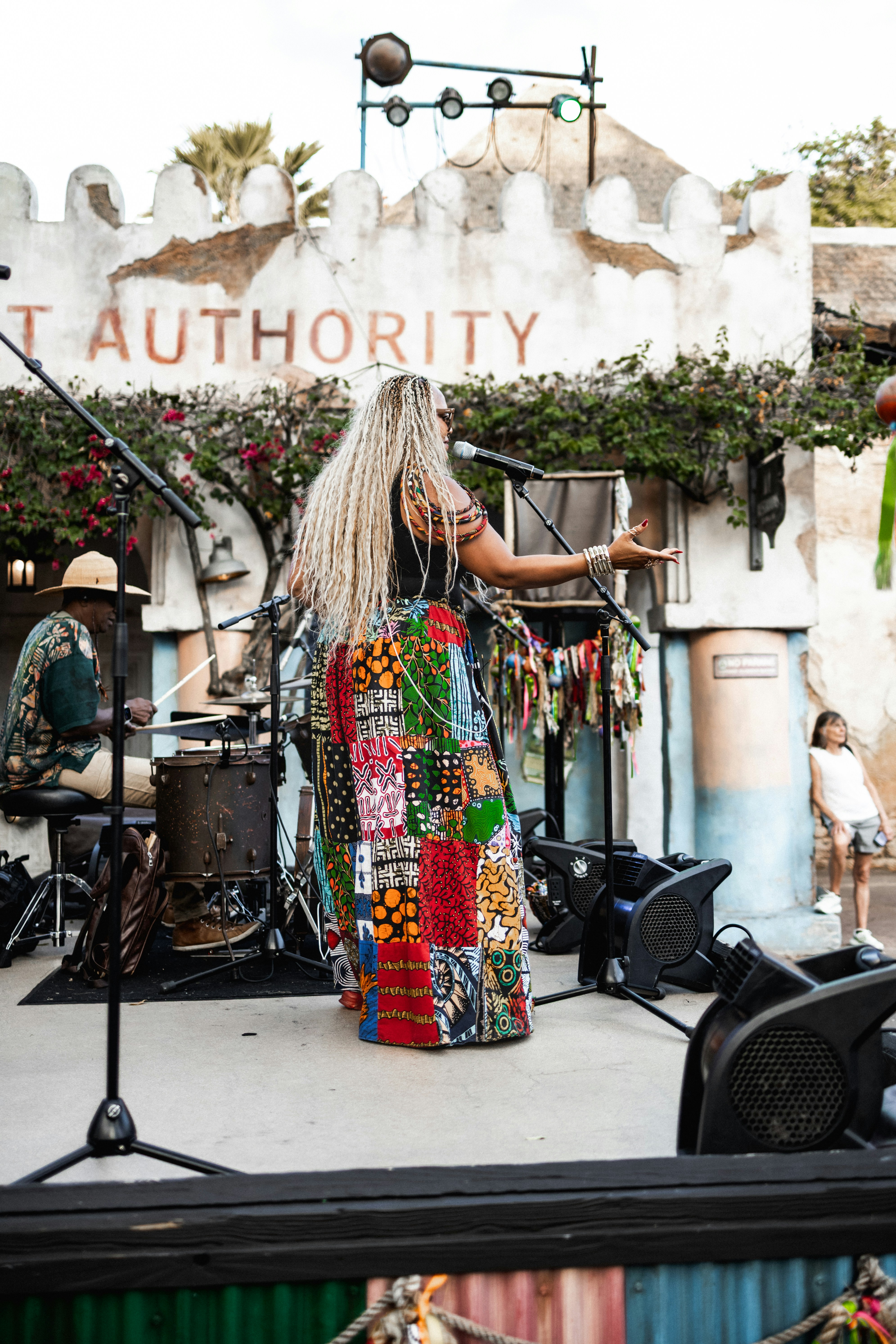Woman in a colorful skirt performs on stage.
