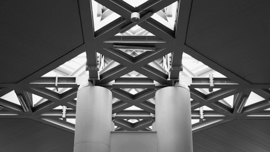 Modern architectural structure with geometric patterns and pillars.