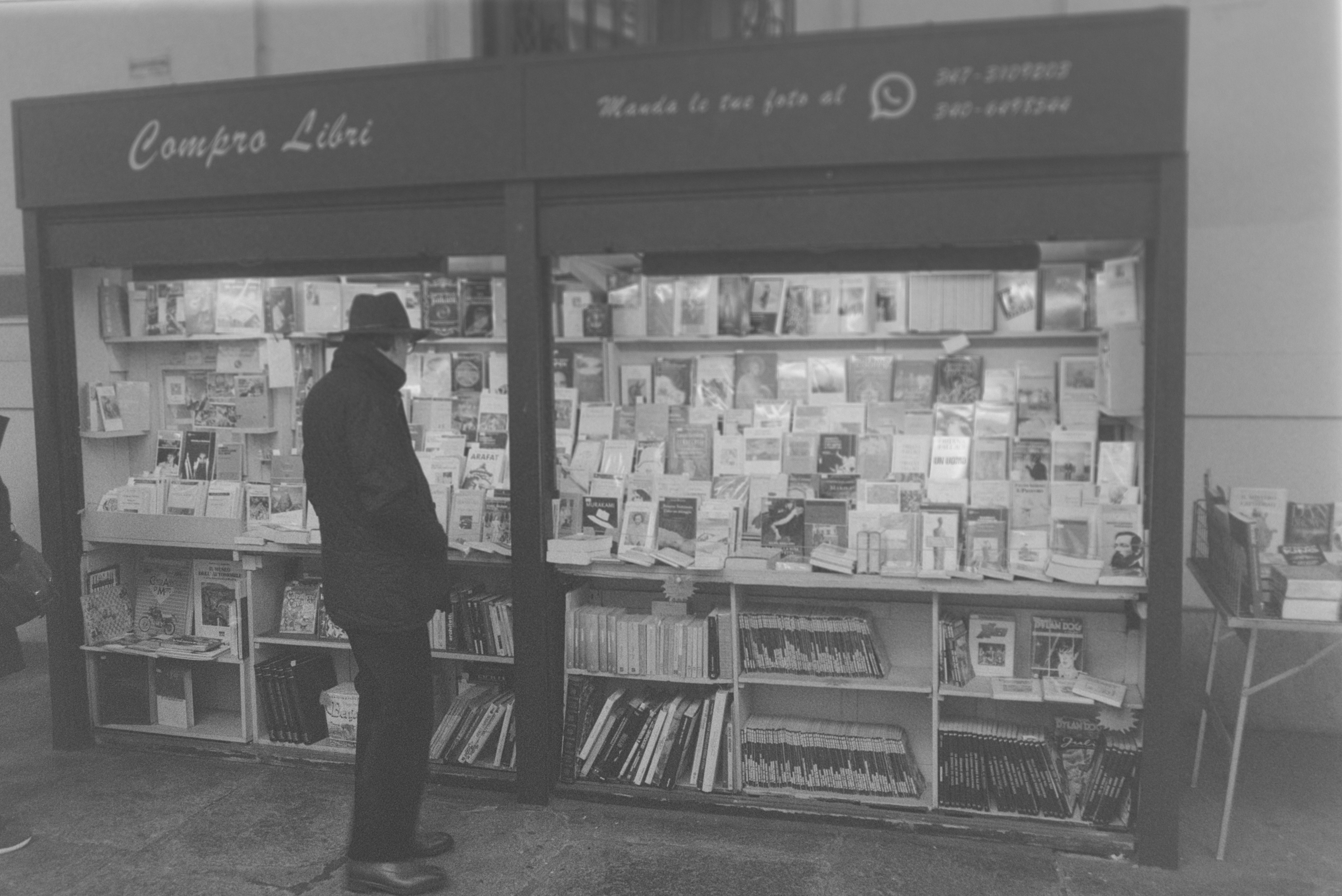 Man browsing books at a store stall