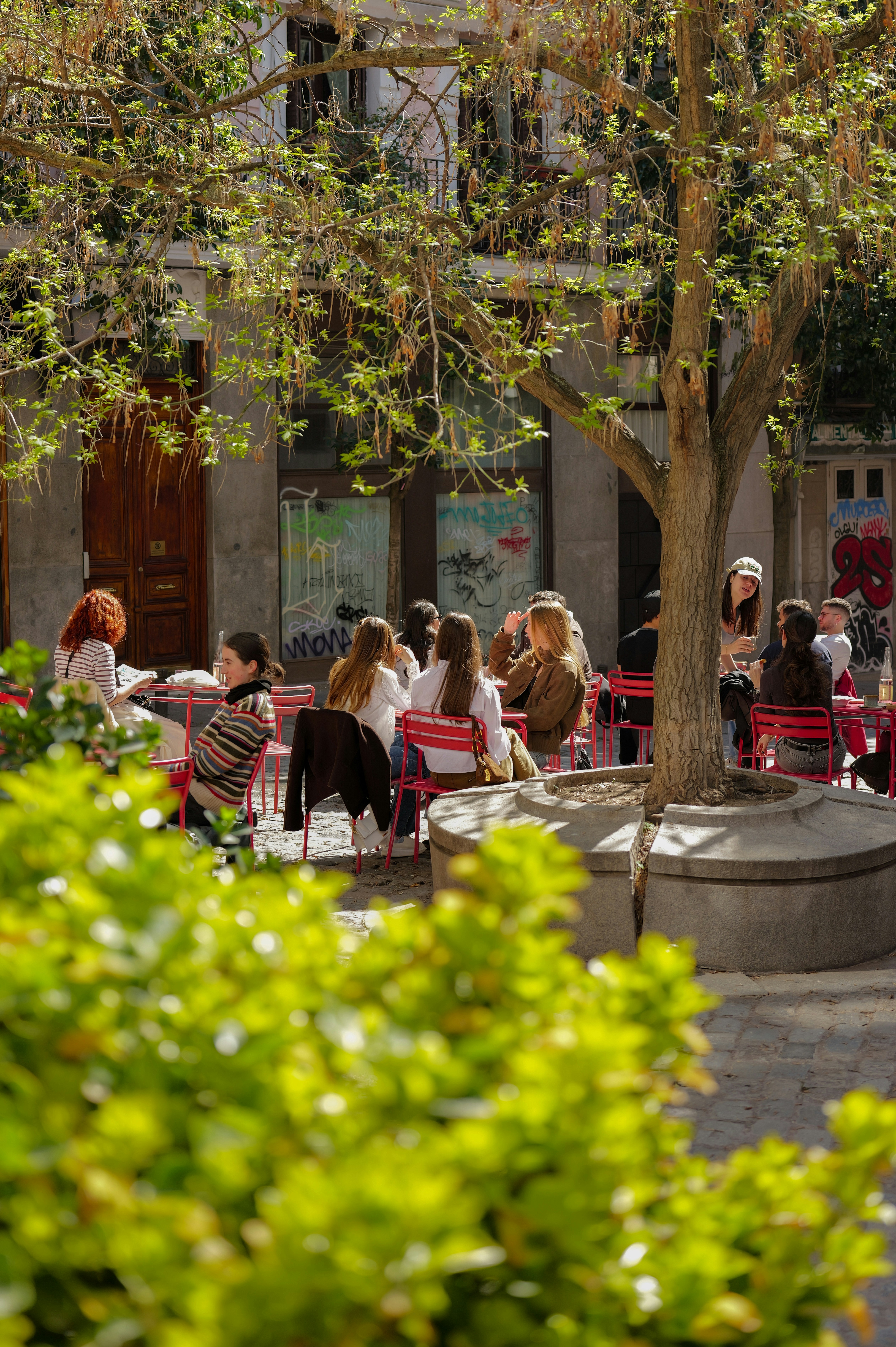 People enjoying a sunny day at an outdoor cafe.