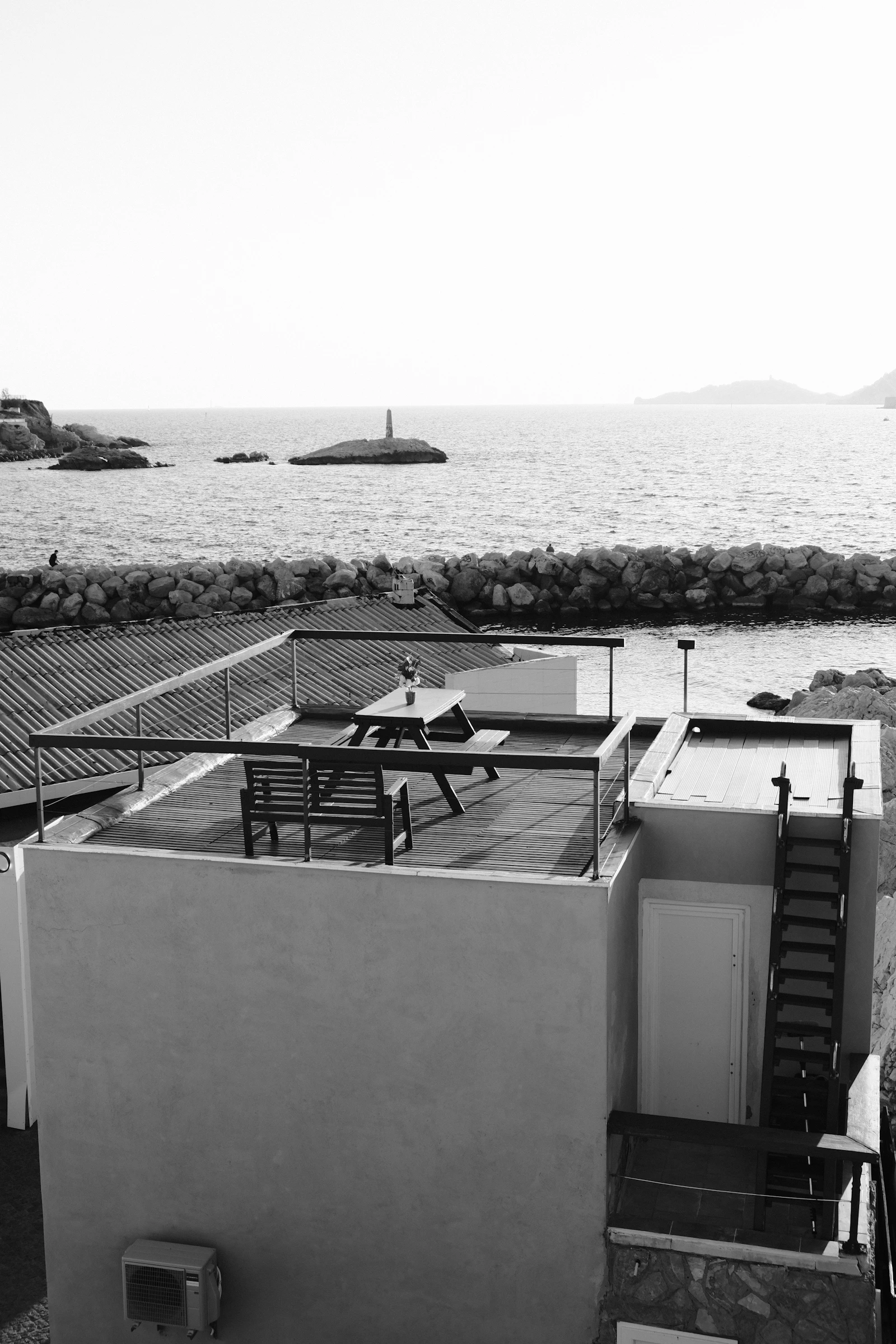 Rooftop terrace of a hillside villa overlooking the Mediterranean at dusk